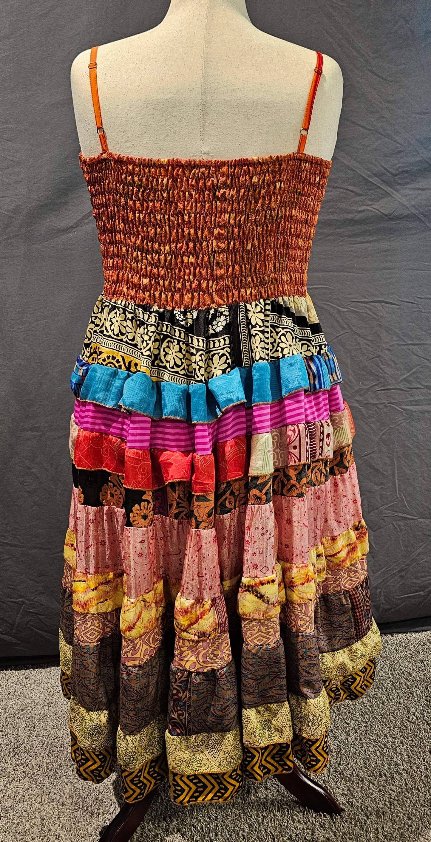 Sustainable sari dress, related to Kantha tradition of reusing textiles with artistry.