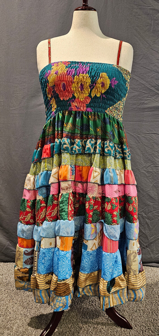 Upcycled sari dress front in vibrant colors, part of Wild Kantha’s artisan clothing collection.
