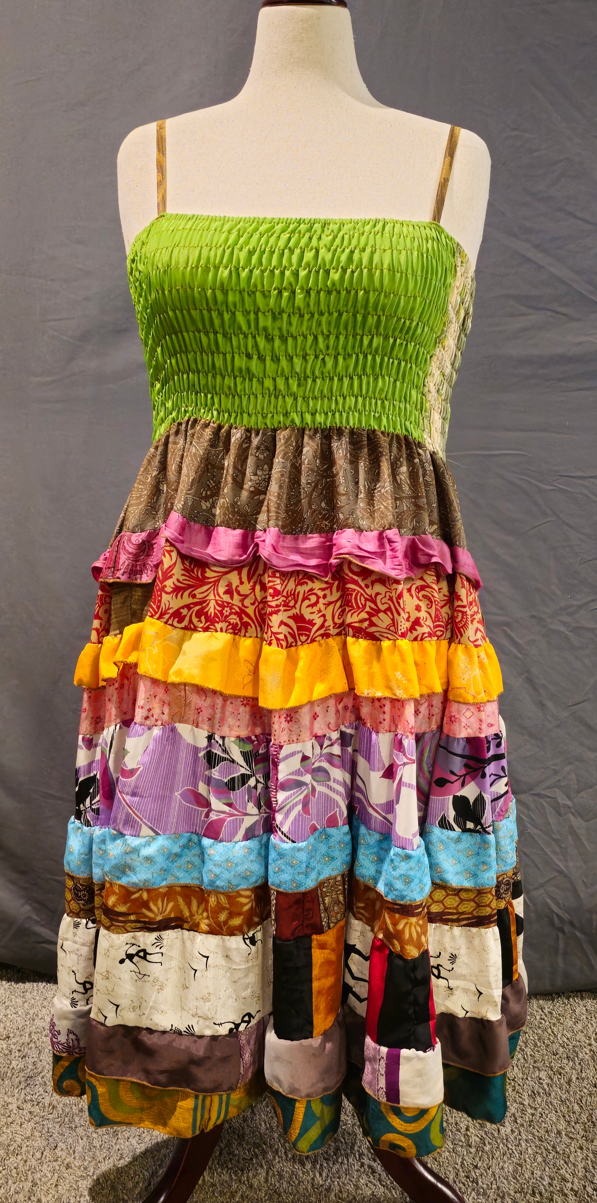 Meadowlark boho patchwork tiered dress in green, gold, pink, and blue, one-of-a-kind sustainable fashion.