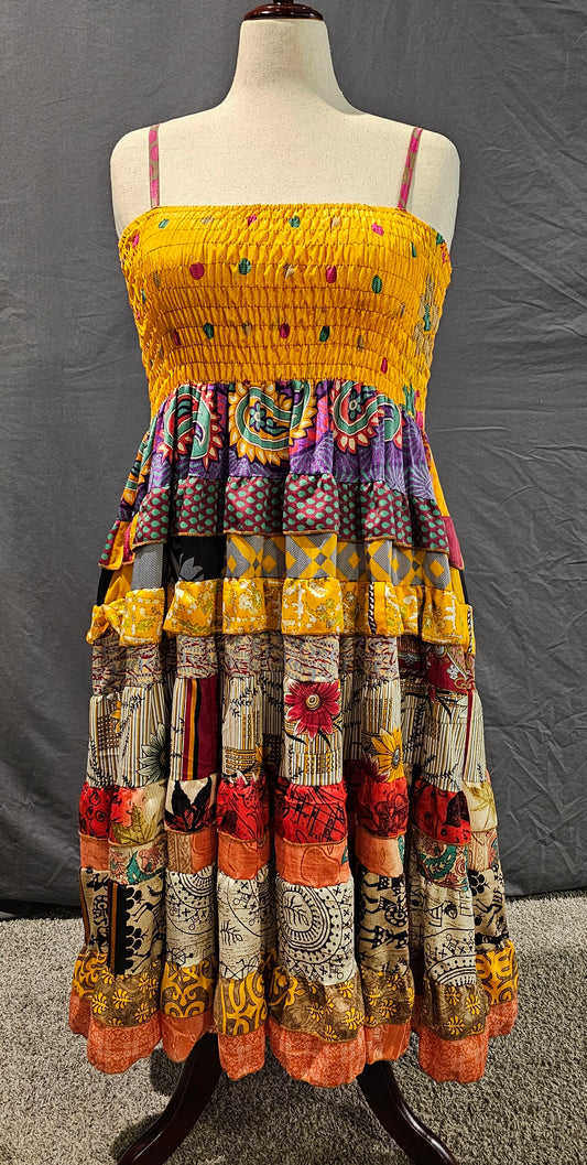 Sustainable sari dress front, related to Kantha tradition of reusing textiles with artistry.