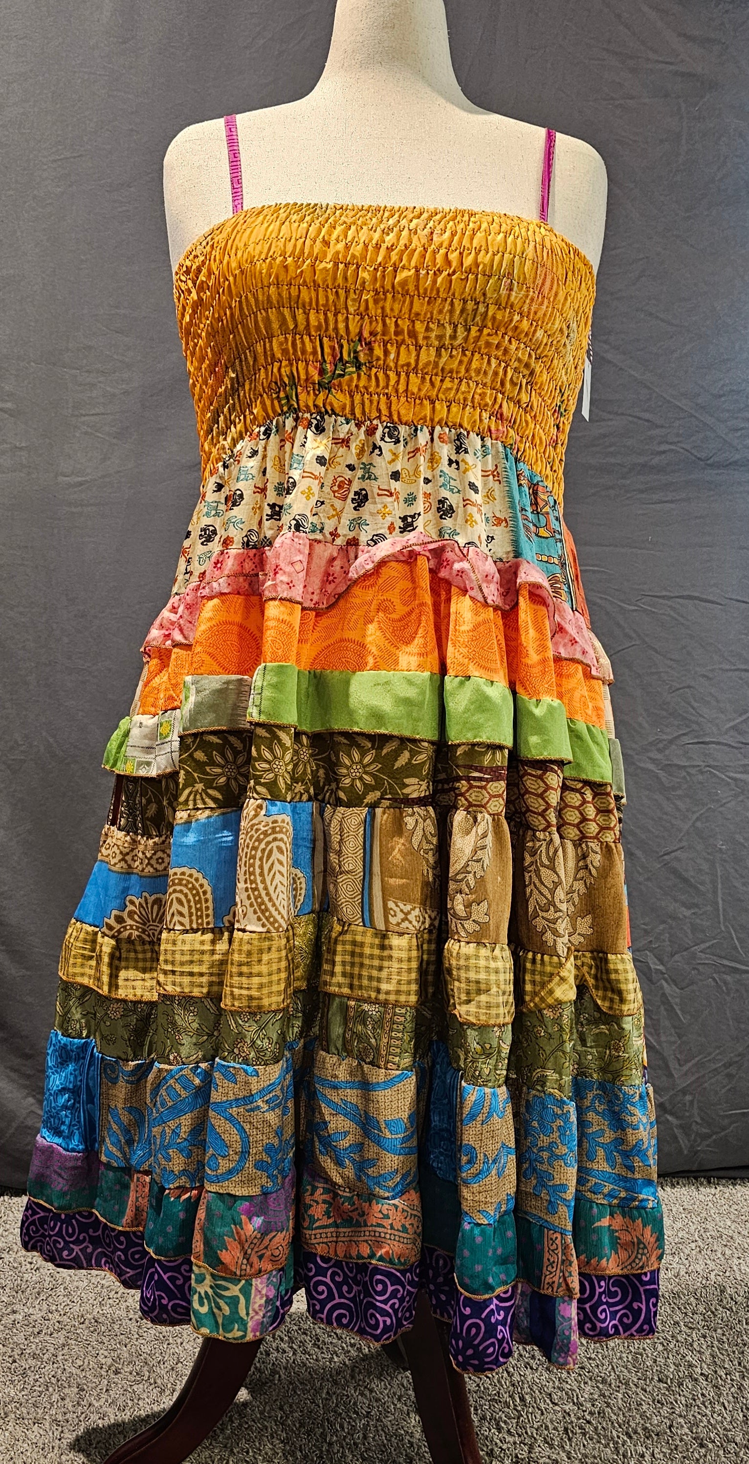 Boho recycled sari dress, handmade from upcycled textiles for sustainable style shown on mannequin.