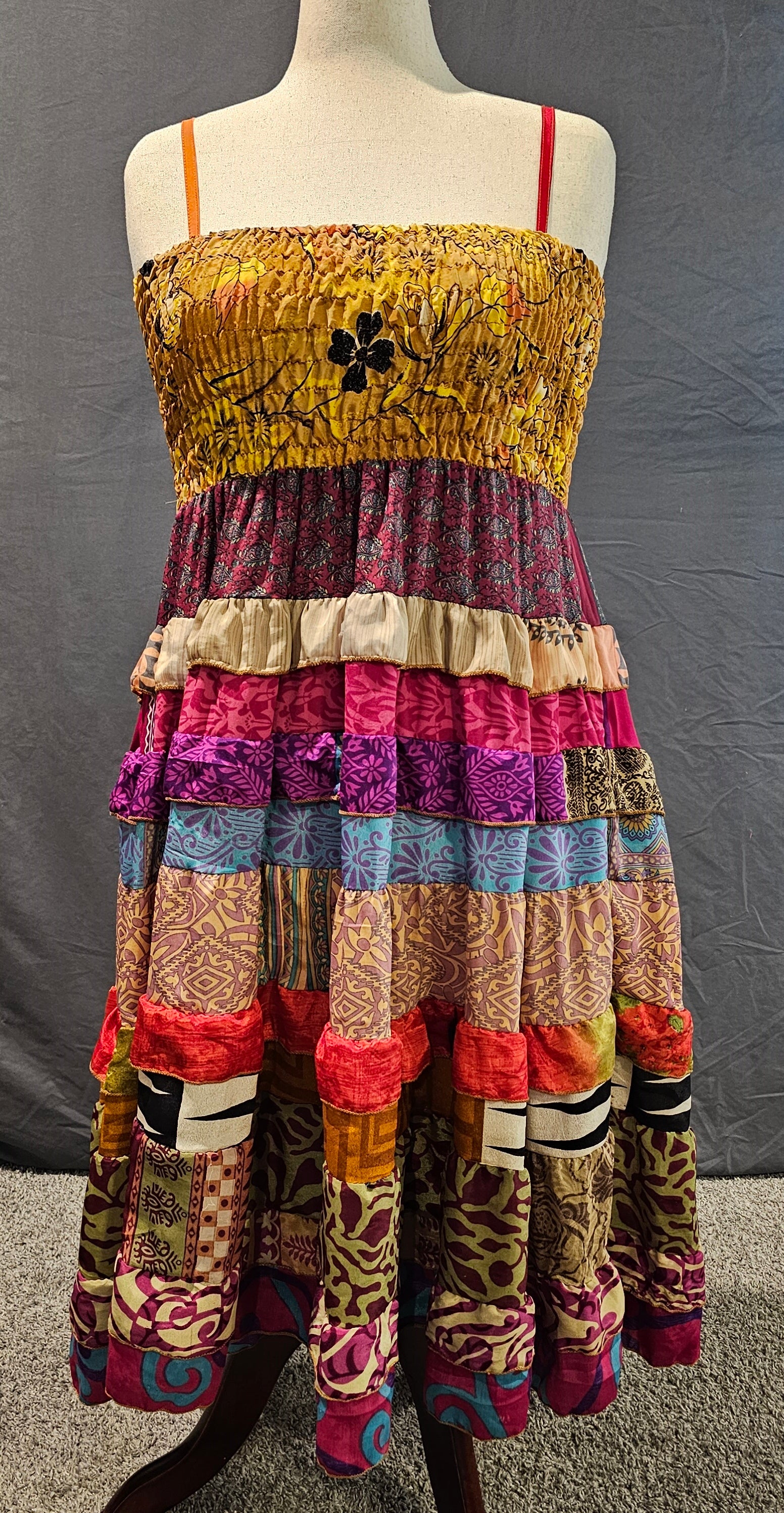Bohemian one-of-a-kind dress crafted from recycled sari fabric shown on mannequin.