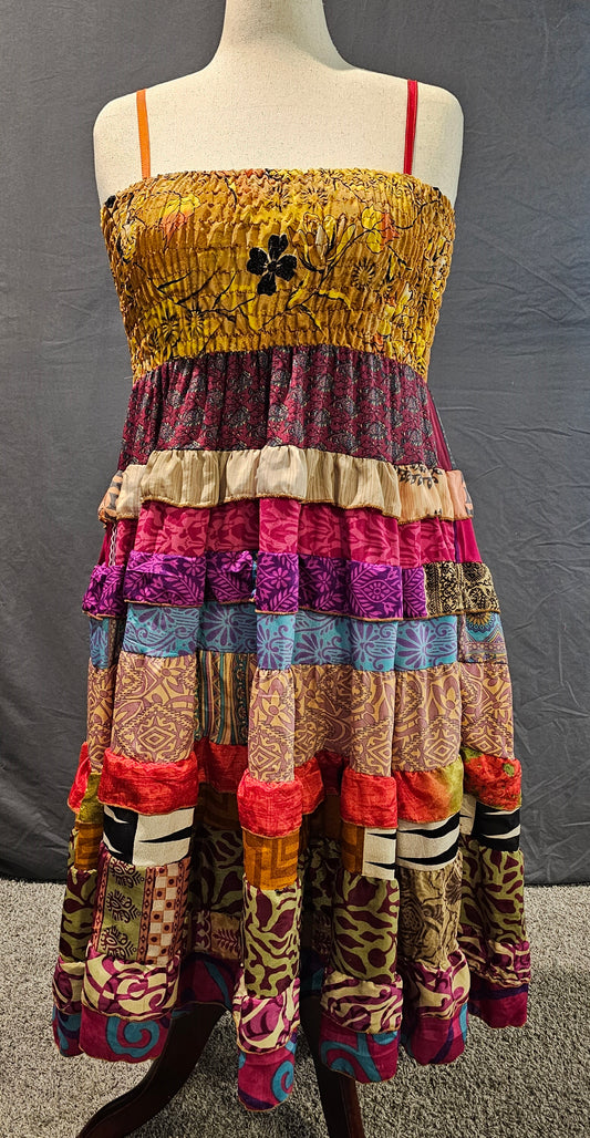 Bohemian one-of-a-kind dress crafted from recycled sari fabric shown on mannequin.
