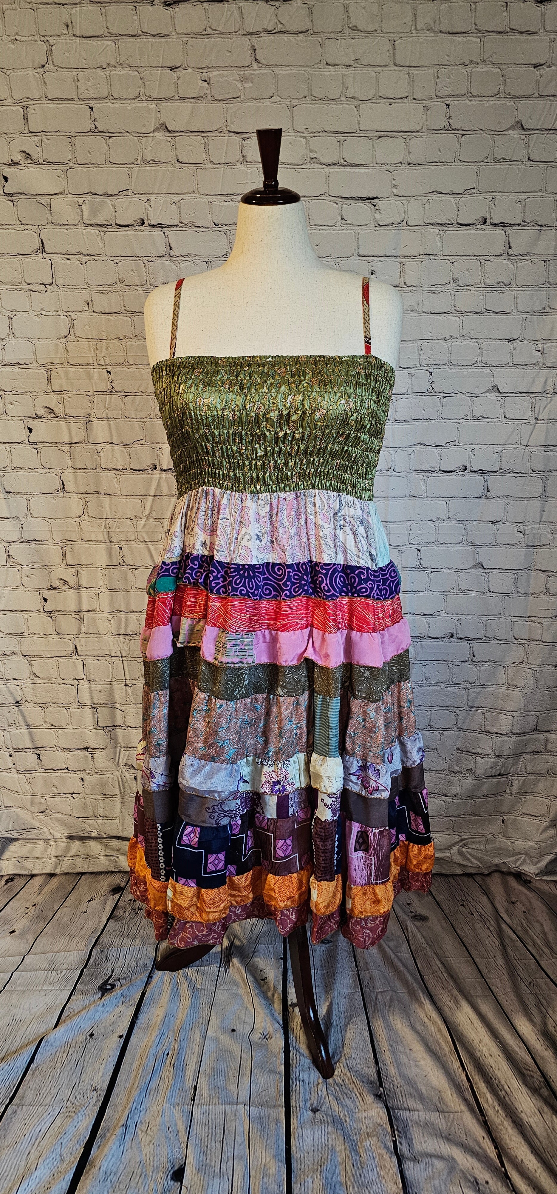 Boho recycled sari dress with vibrant patterns and adaptable fit shown on mannequin.