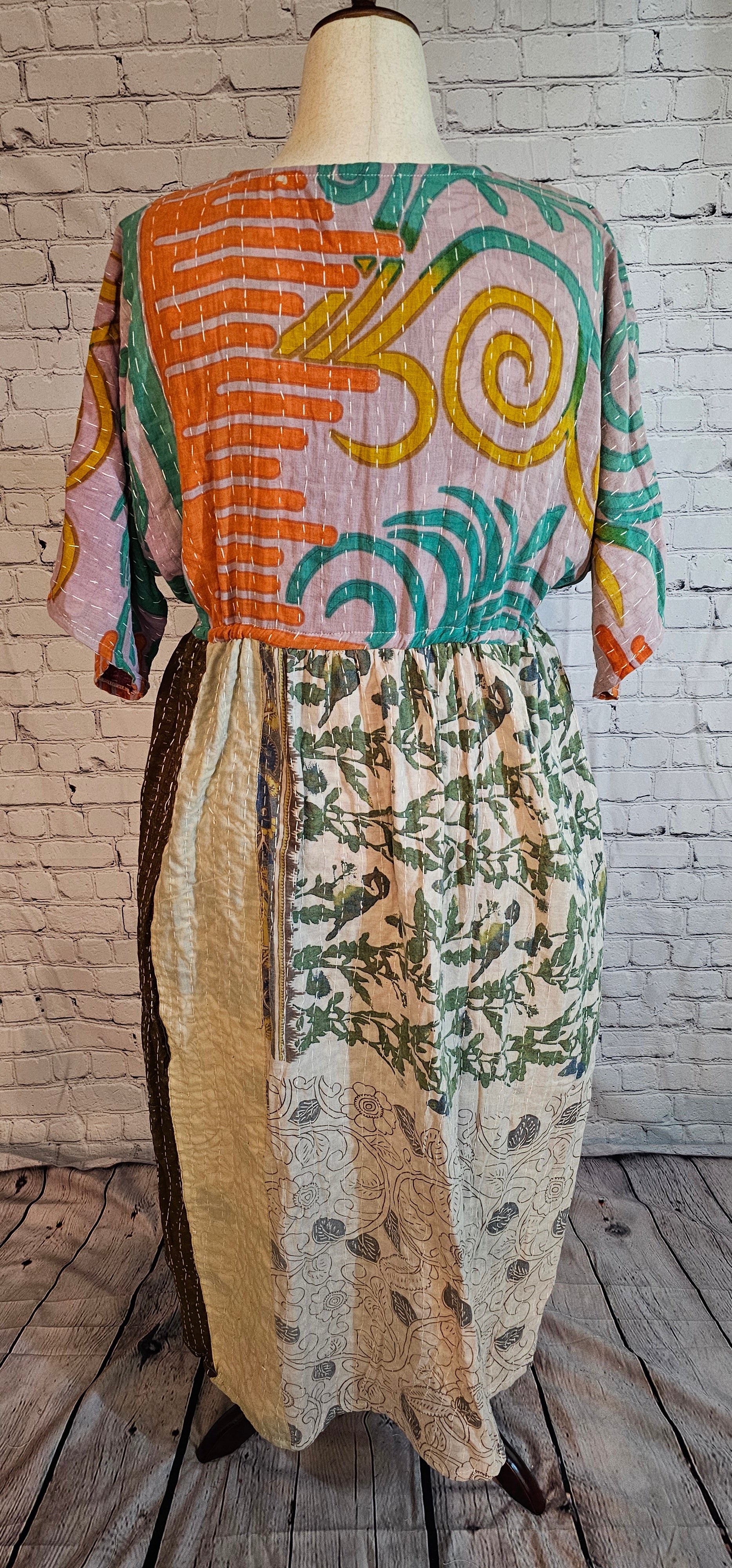 Mosswynd cotton Kantha dress, bohemian patchwork design with flowing fit shown on mannequin.