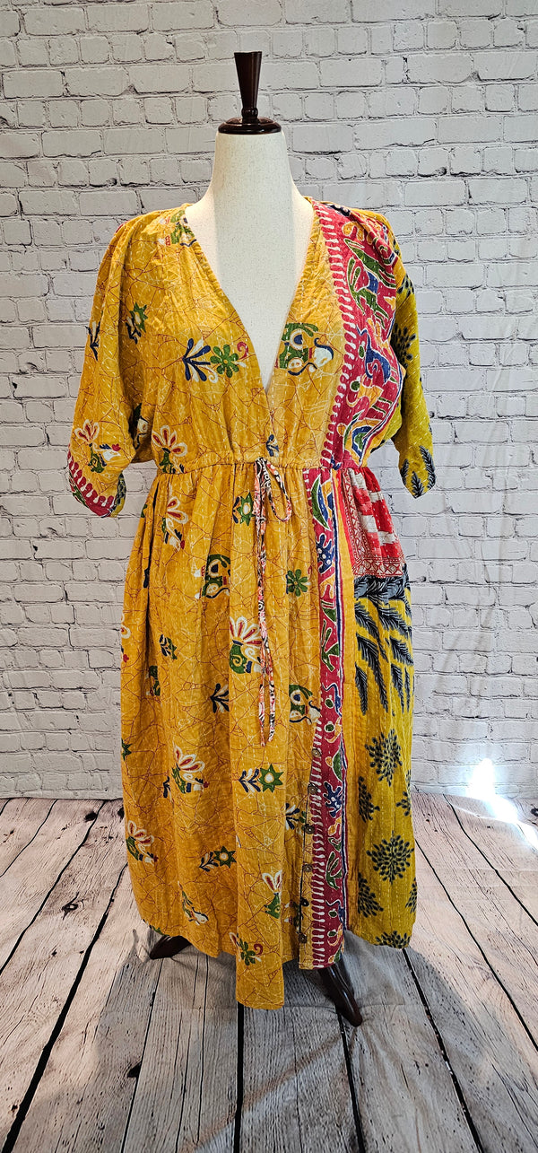 Mosswynd cotton Kantha dress on mannequin, bohemian patchwork design with flowing fit.
