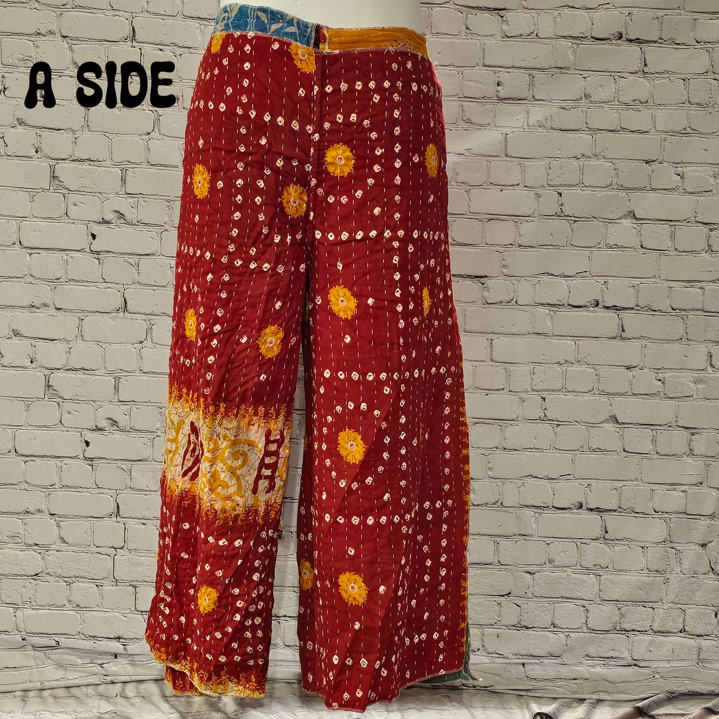 Front view of Ronin Kantha unisex wrap pants, made from recycled sari fabric in boho patchwork design.