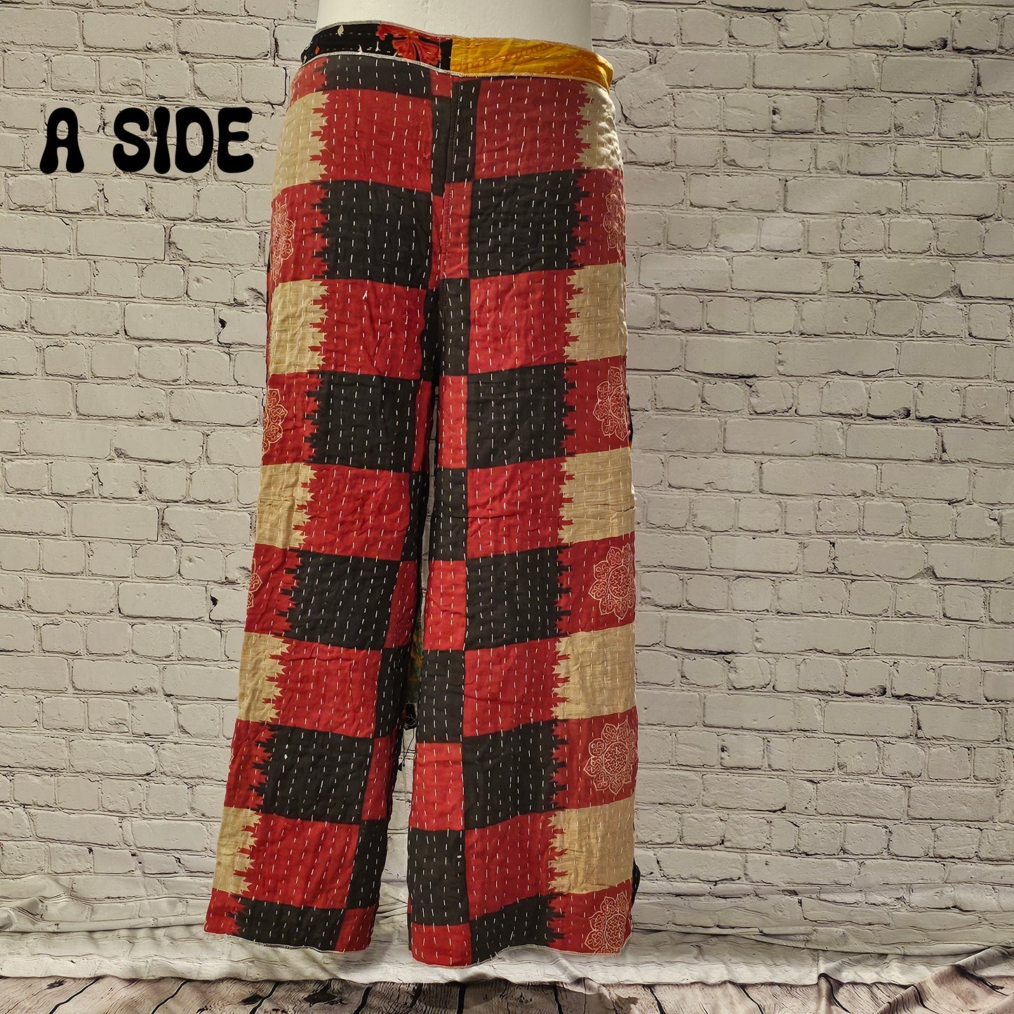 Front view of Ronin Kantha unisex wrap pants, made from recycled sari fabric in boho patchwork design.