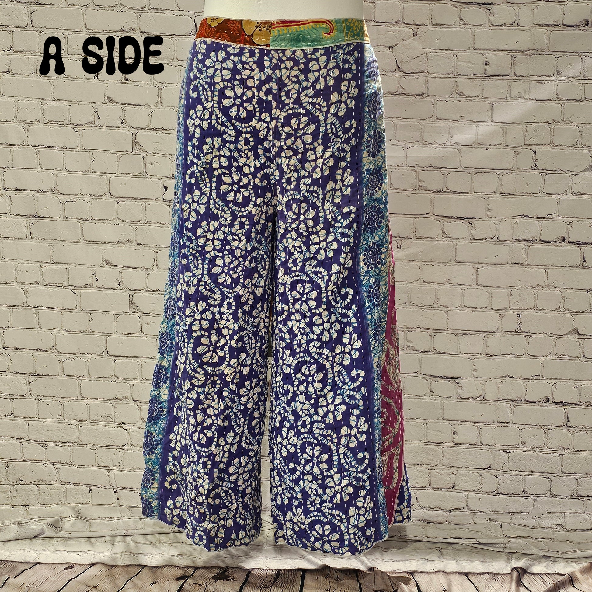 Front view of Ronin Kantha unisex wrap pants, made from recycled sari fabric in boho patchwork design.