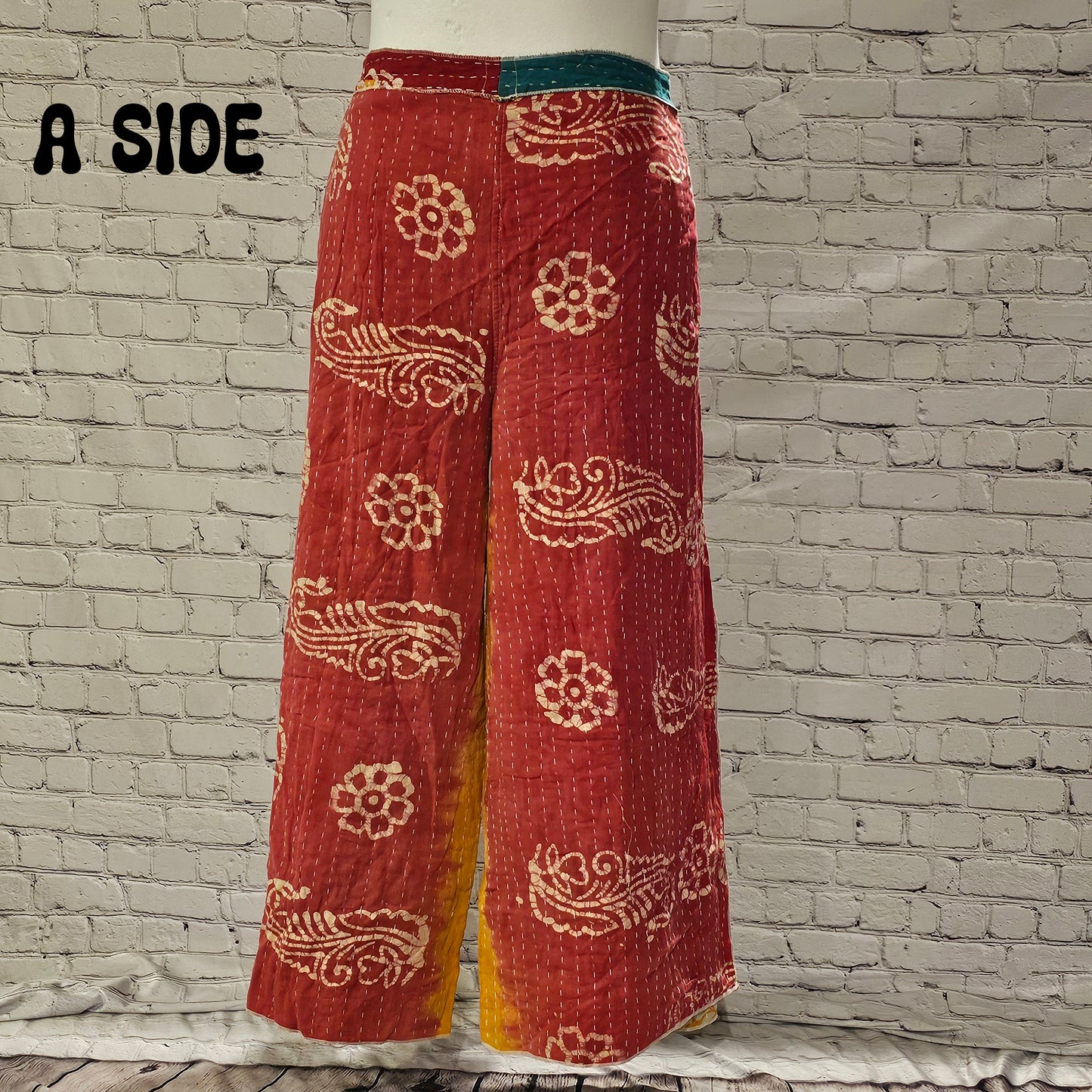 Front view of Ronin Kantha unisex wrap pants, made from recycled sari fabric in boho patchwork design.