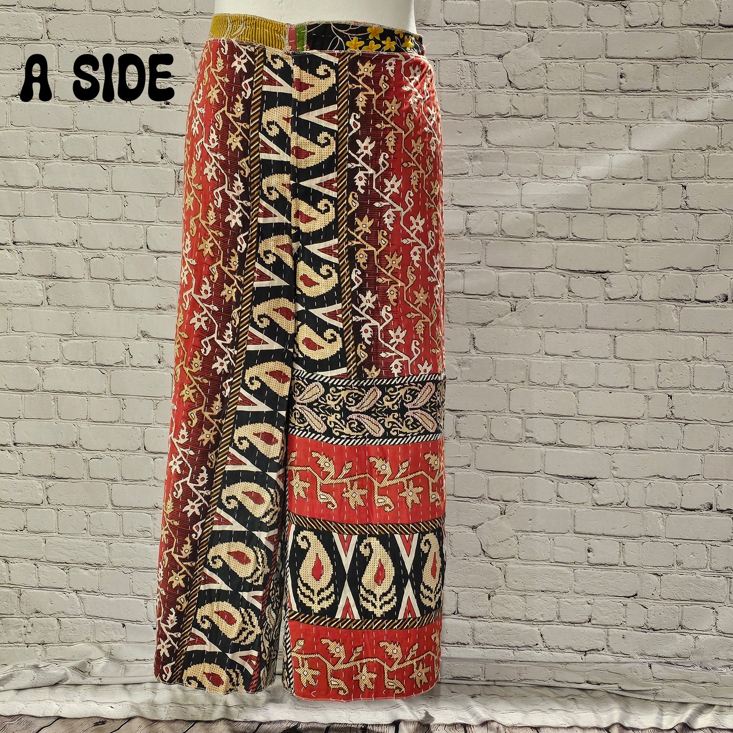 Front view of Ronin Kantha unisex wrap pants, made from recycled sari fabric in boho patchwork design.