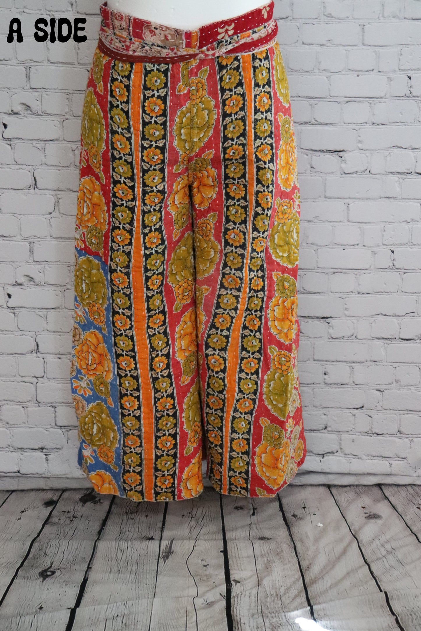Front view of Ronin Kantha unisex wrap pants, made from recycled sari fabric in boho patchwork design.