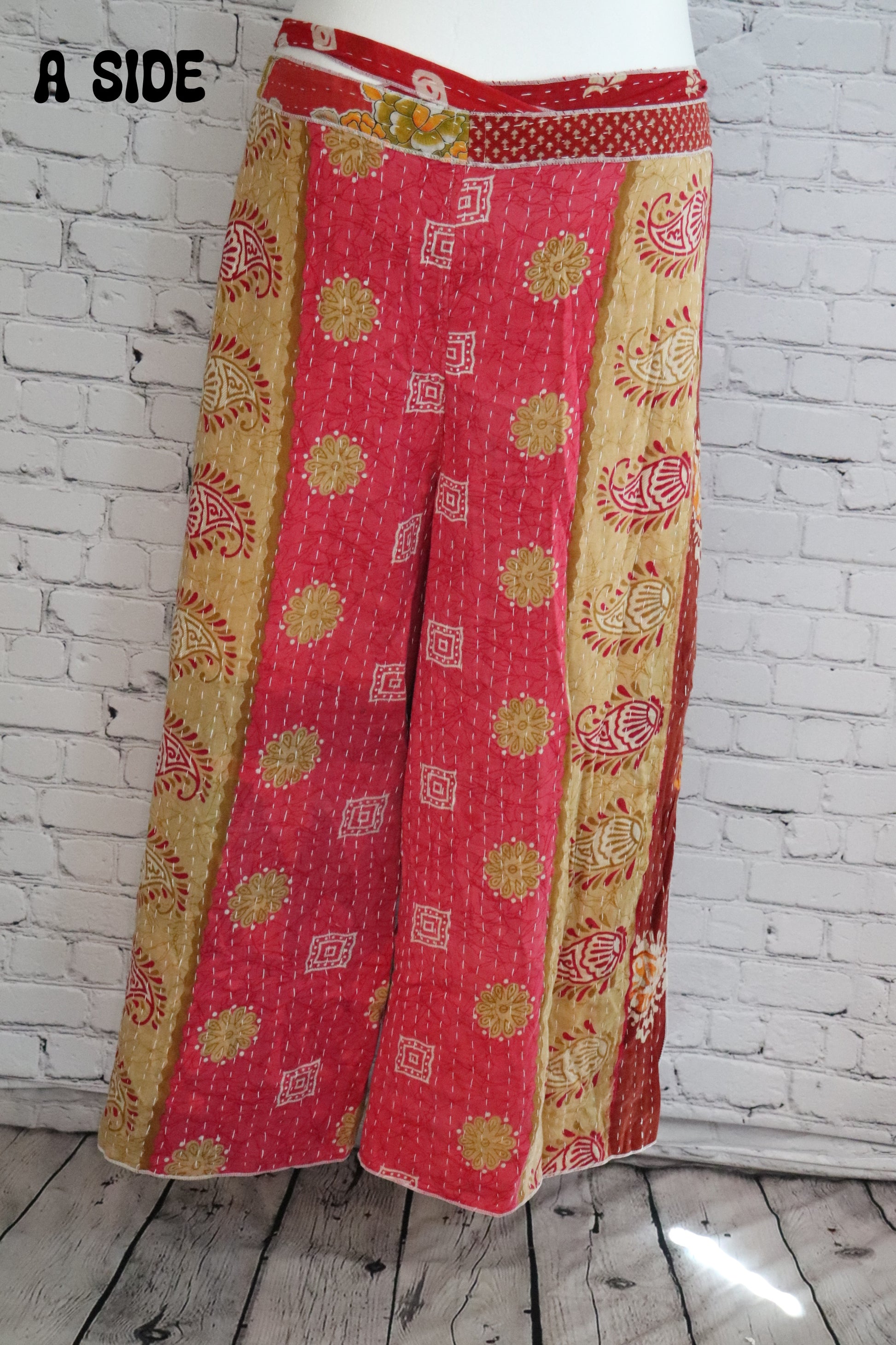 Front view of Ronin Kantha unisex wrap pants, made from recycled sari fabric in boho patchwork design.