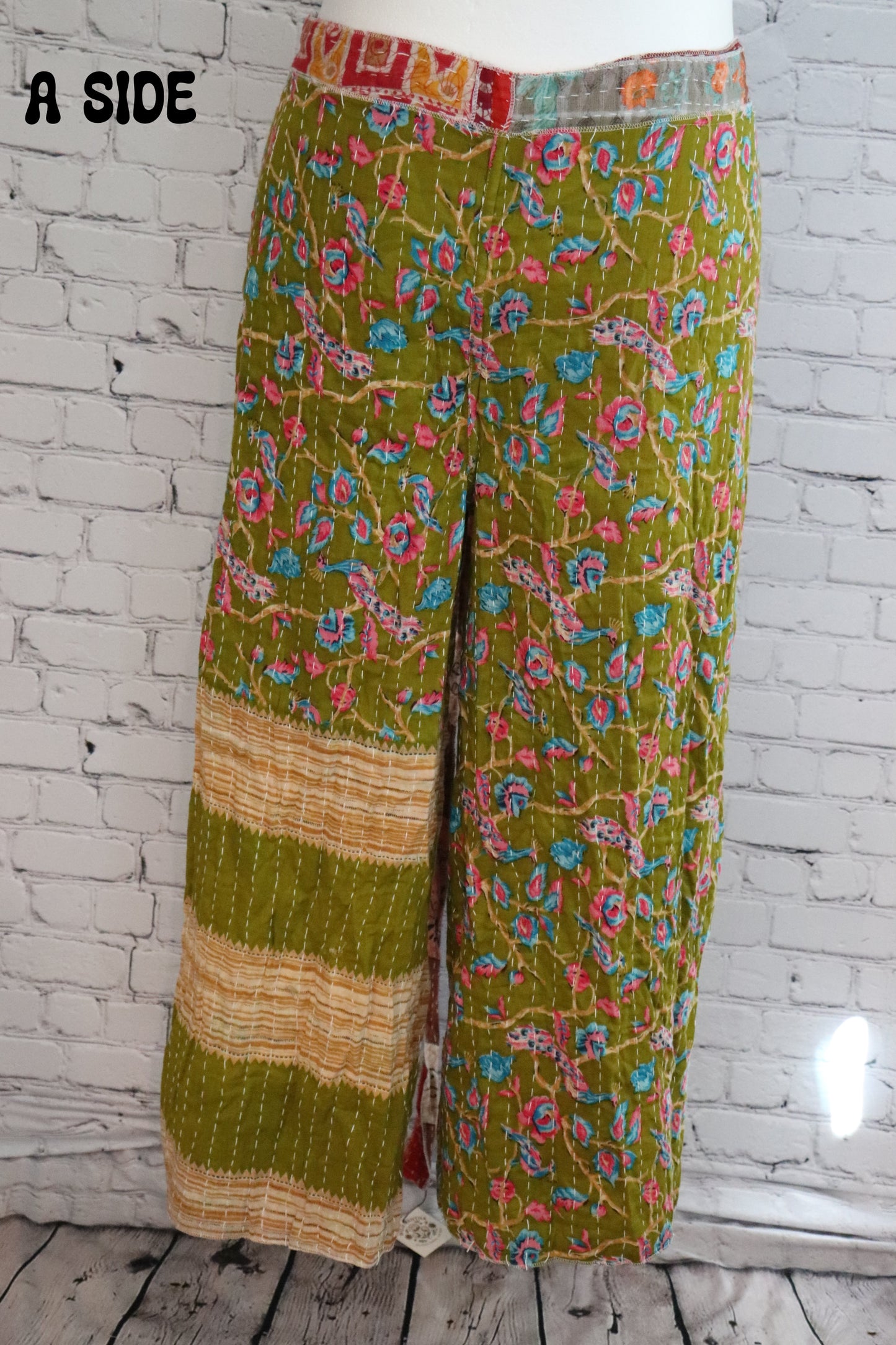 Front view of Ronin Kantha unisex wrap pants, made from recycled sari fabric in boho patchwork design.