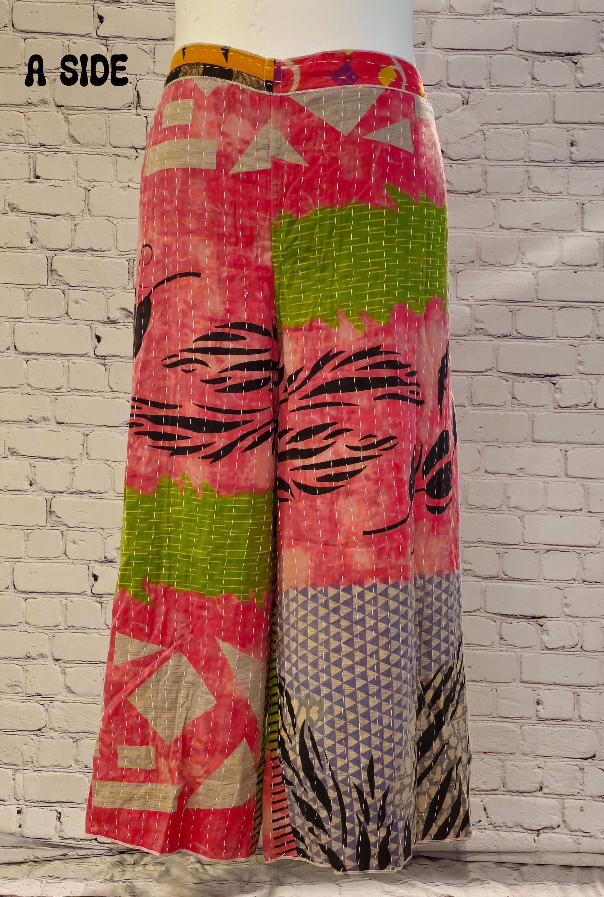 Front view of Ronin Kantha unisex wrap pants, made from recycled sari fabric in boho patchwork design.