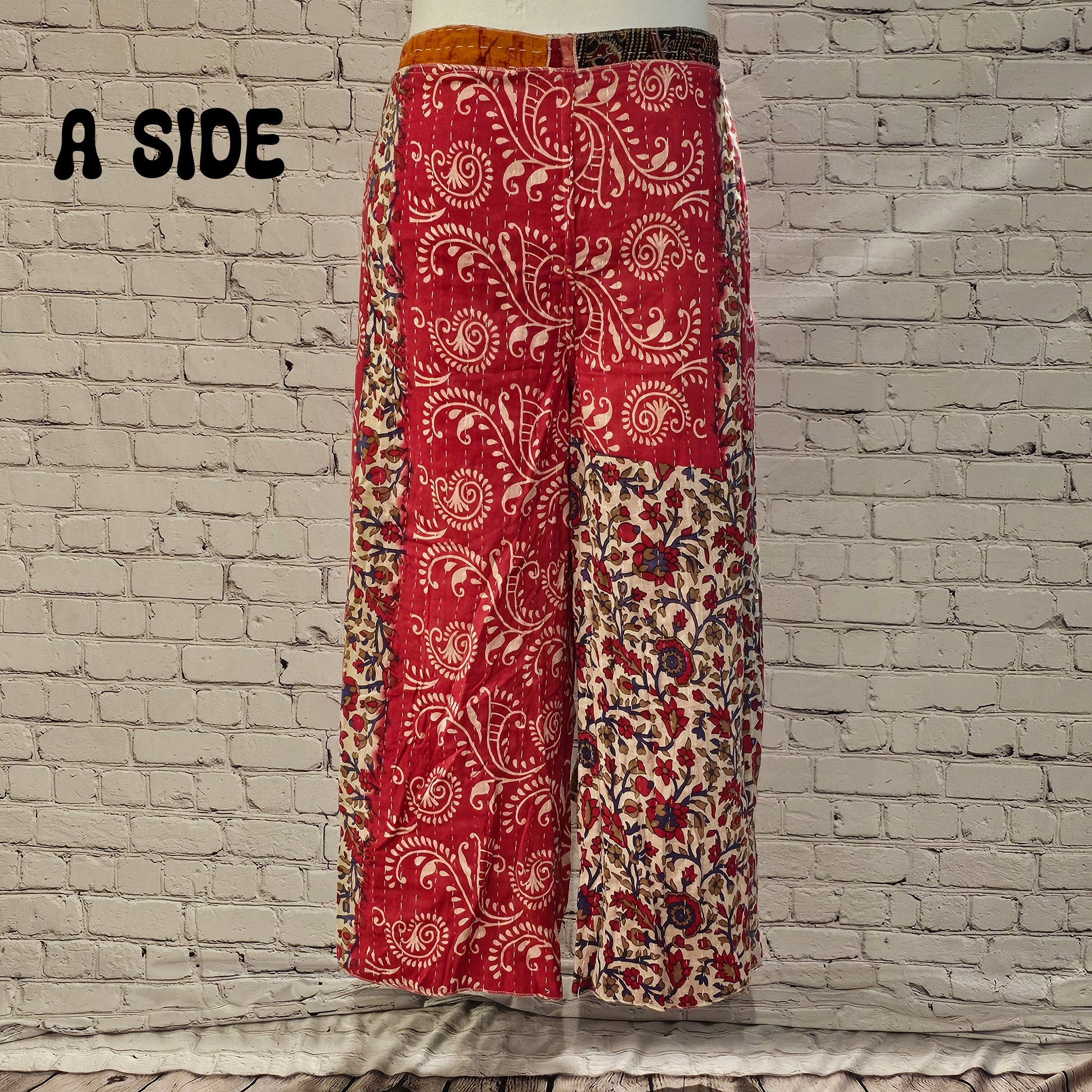 Front view of Ronin Kantha unisex wrap pants, made from recycled sari fabric in boho patchwork design.