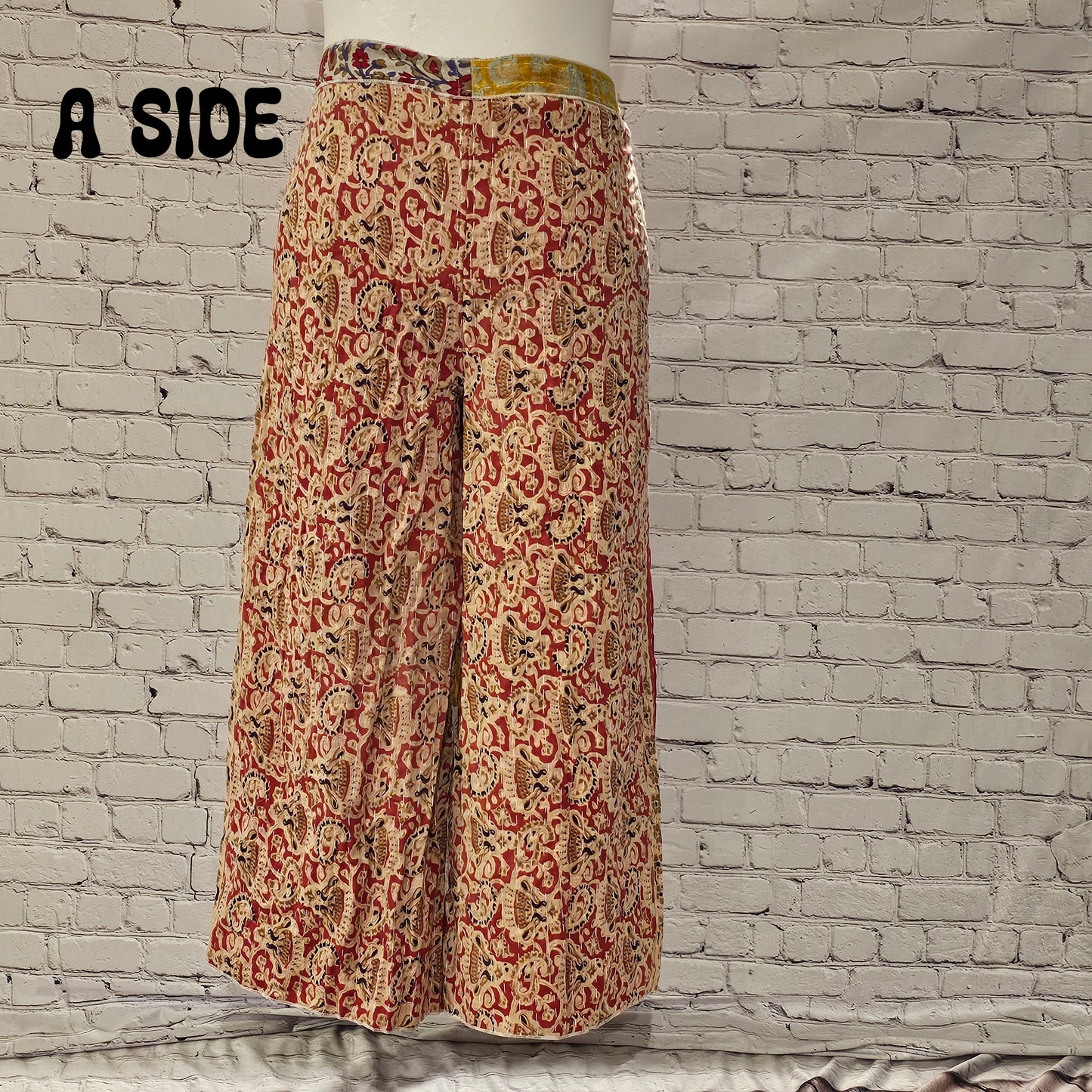 Front view of Ronin Kantha unisex wrap pants, made from recycled sari fabric in boho patchwork design.