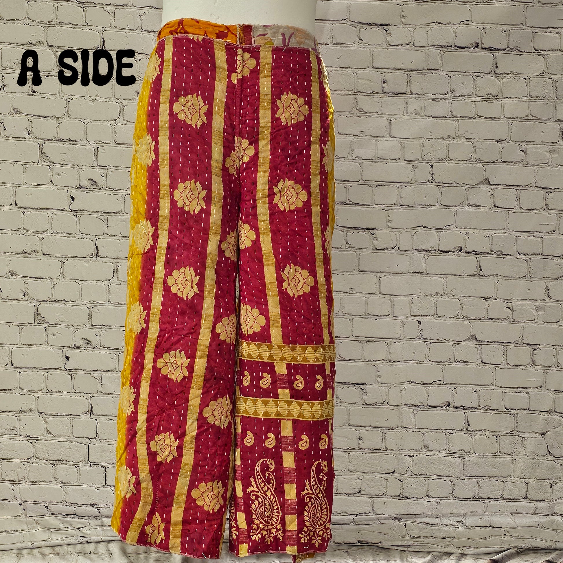 Front view of Ronin Kantha unisex wrap pants, made from recycled sari fabric in boho patchwork design.