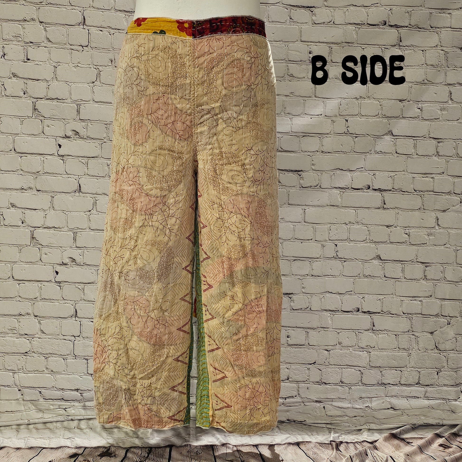 Front view of Ronin Kantha unisex wrap pants, made from recycled sari fabric in boho patchwork design.