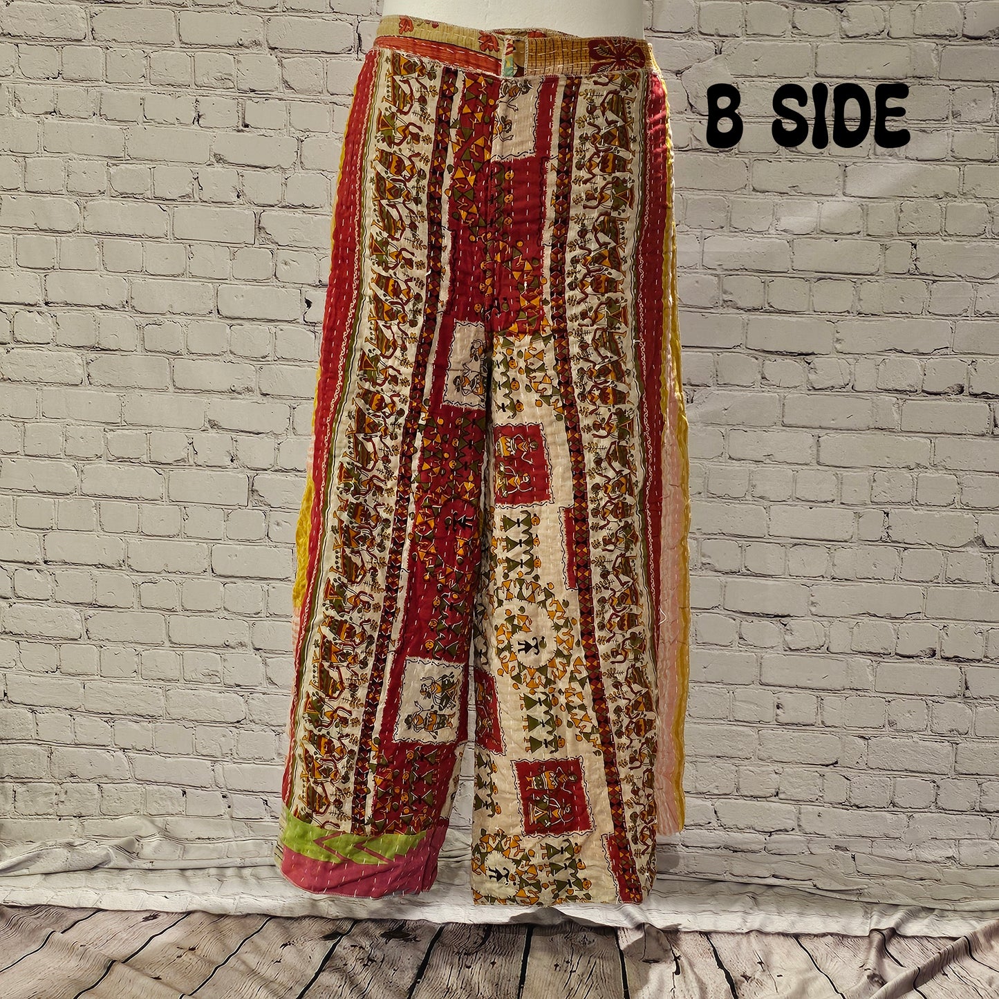 Front view of Ronin Kantha unisex wrap pants, made from recycled sari fabric in boho patchwork design.
