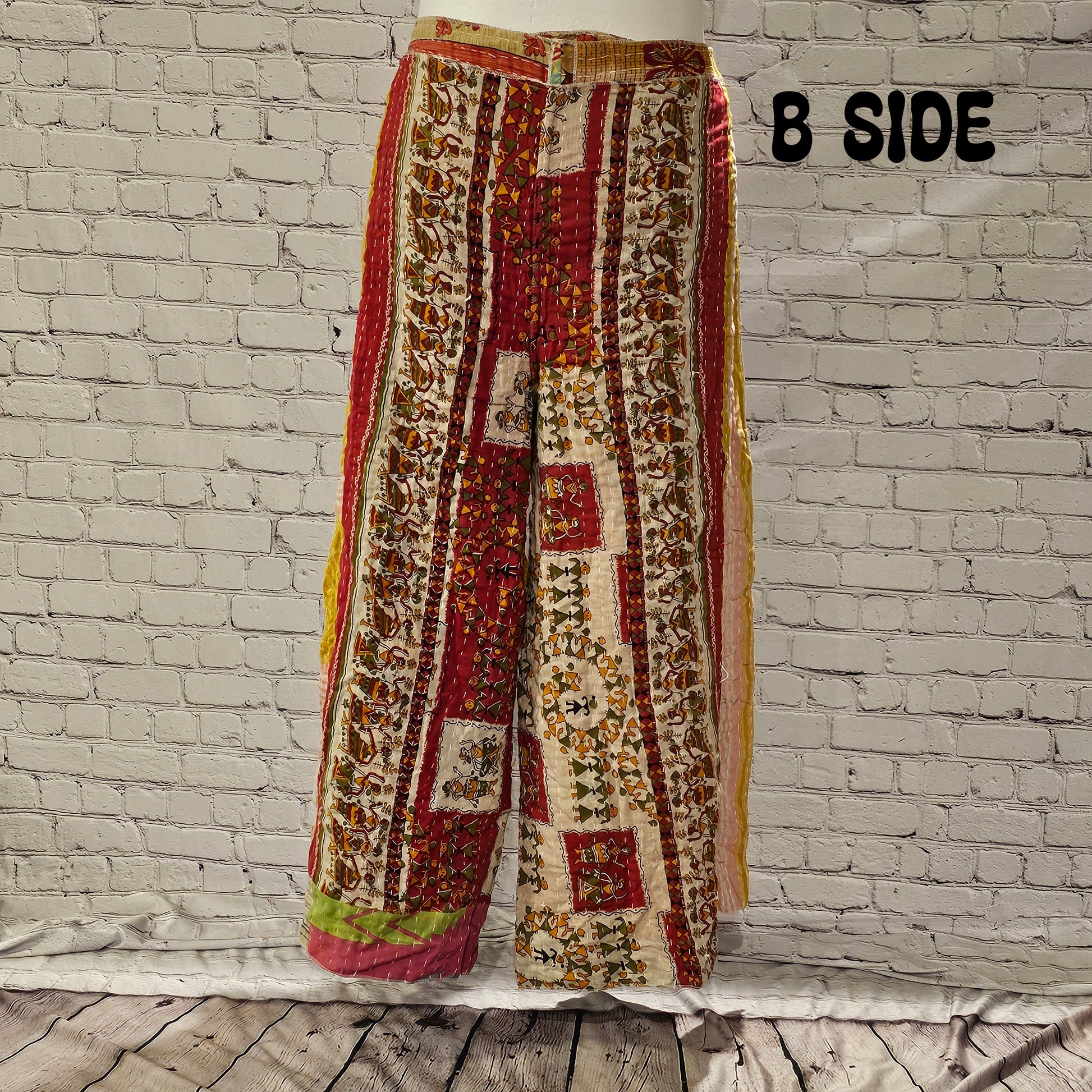 Front view of Ronin Kantha unisex wrap pants, made from recycled sari fabric in boho patchwork design.