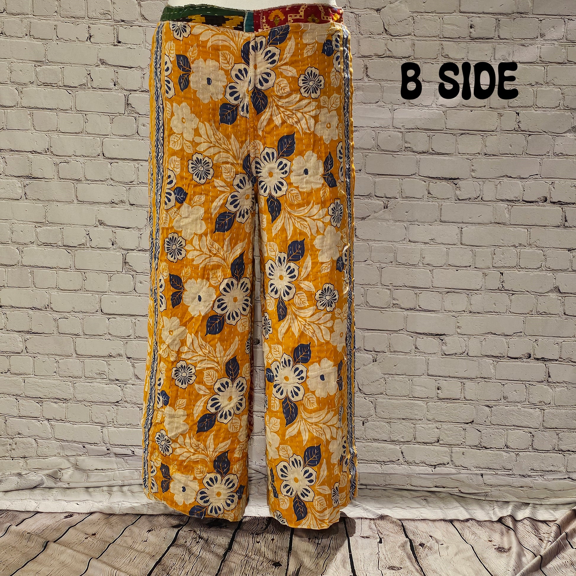 Front view of Ronin Kantha unisex wrap pants, made from recycled sari fabric in boho patchwork design.