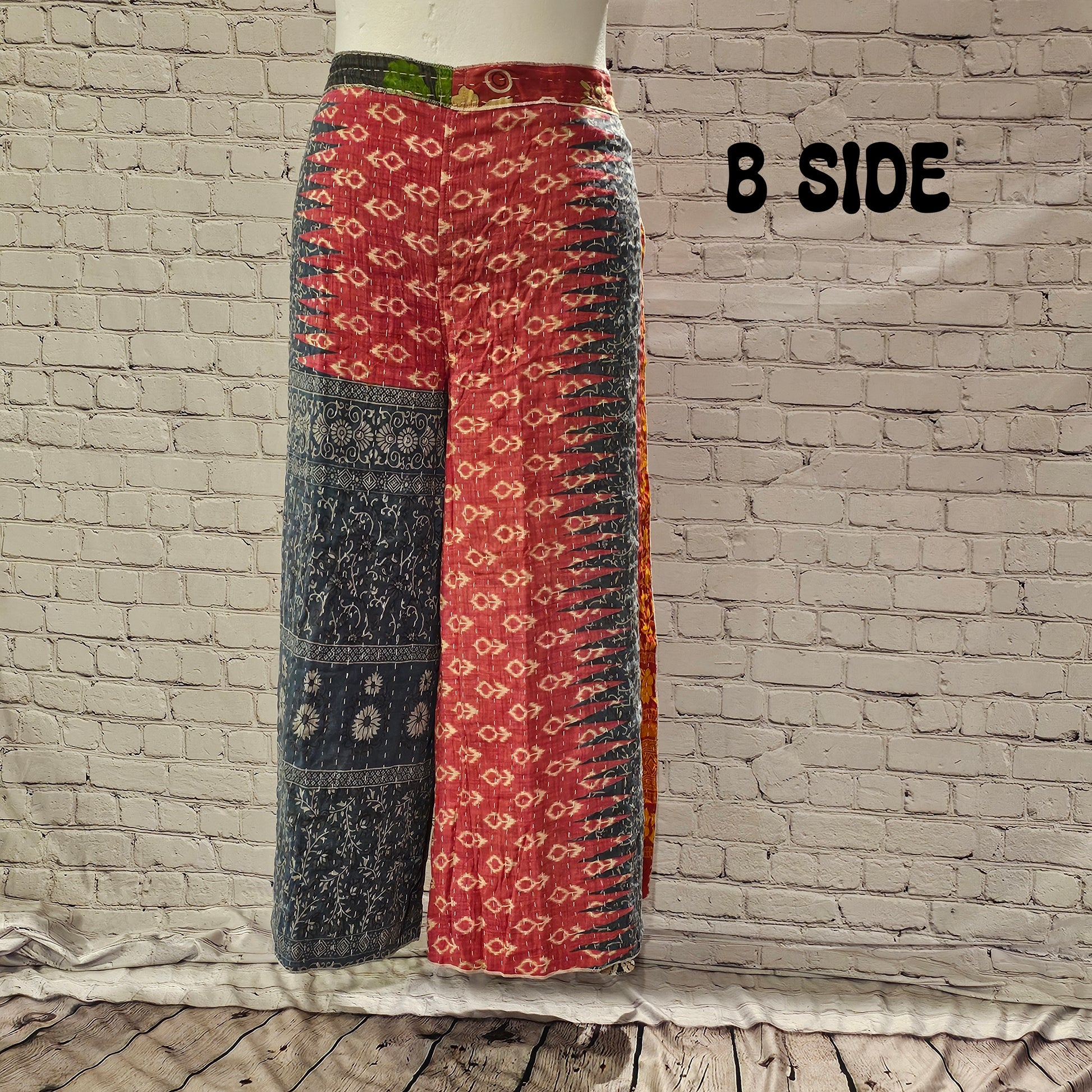 Front view of Ronin Kantha unisex wrap pants, made from recycled sari fabric in boho patchwork design.