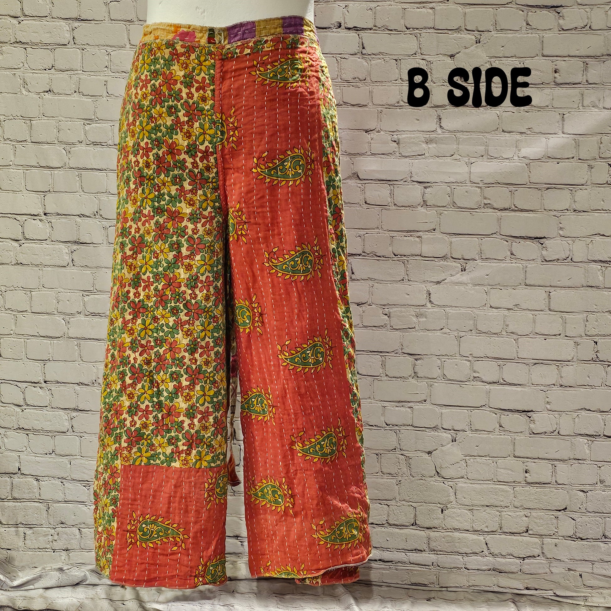 Front view of Ronin Kantha unisex wrap pants, made from recycled sari fabric in boho patchwork design.