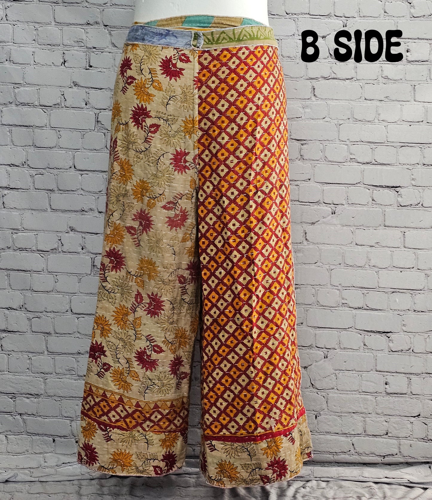 Front view of Ronin Kantha unisex wrap pants, made from recycled sari fabric in boho patchwork design.