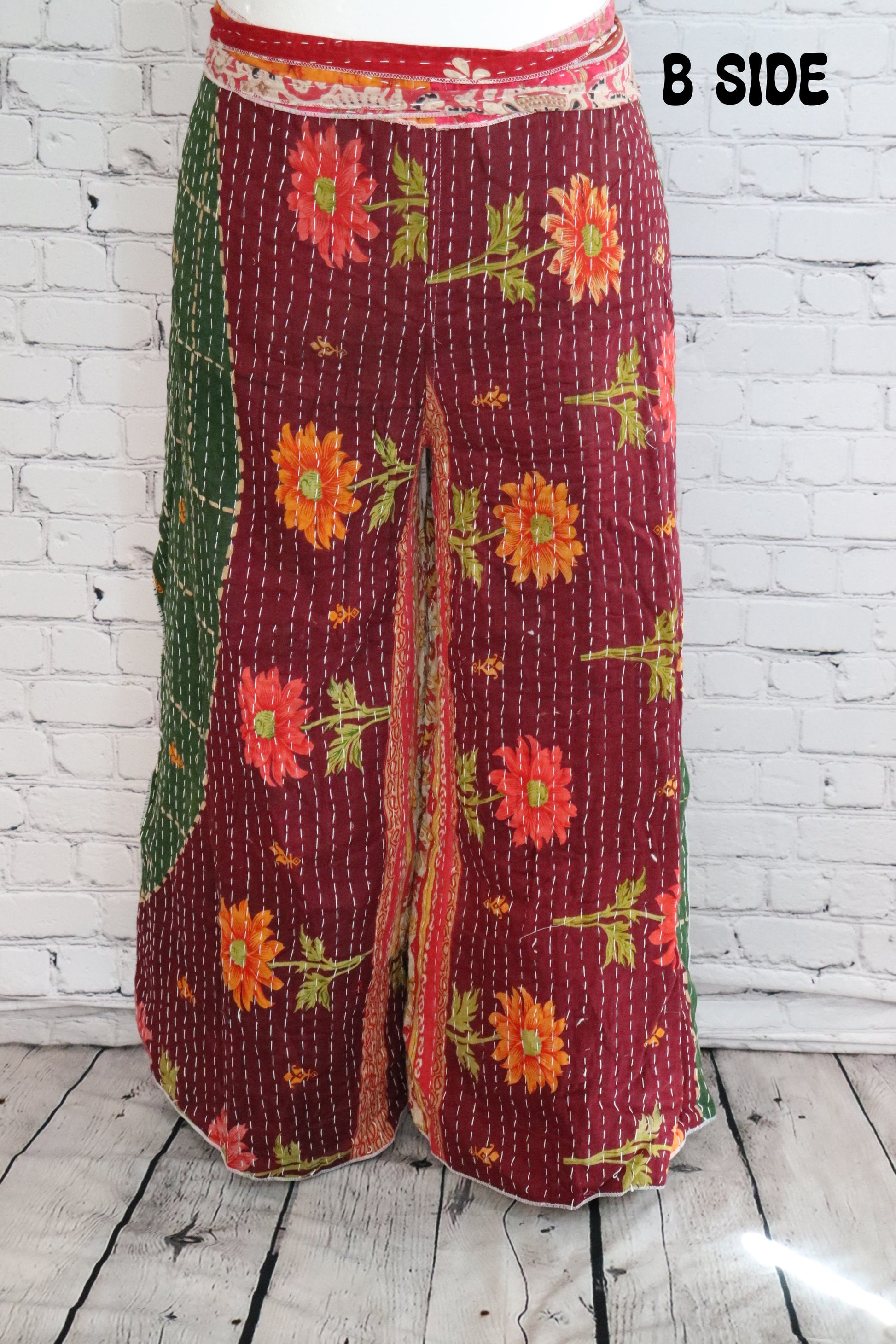 Front view of Ronin Kantha unisex wrap pants, made from recycled sari fabric in boho patchwork design.