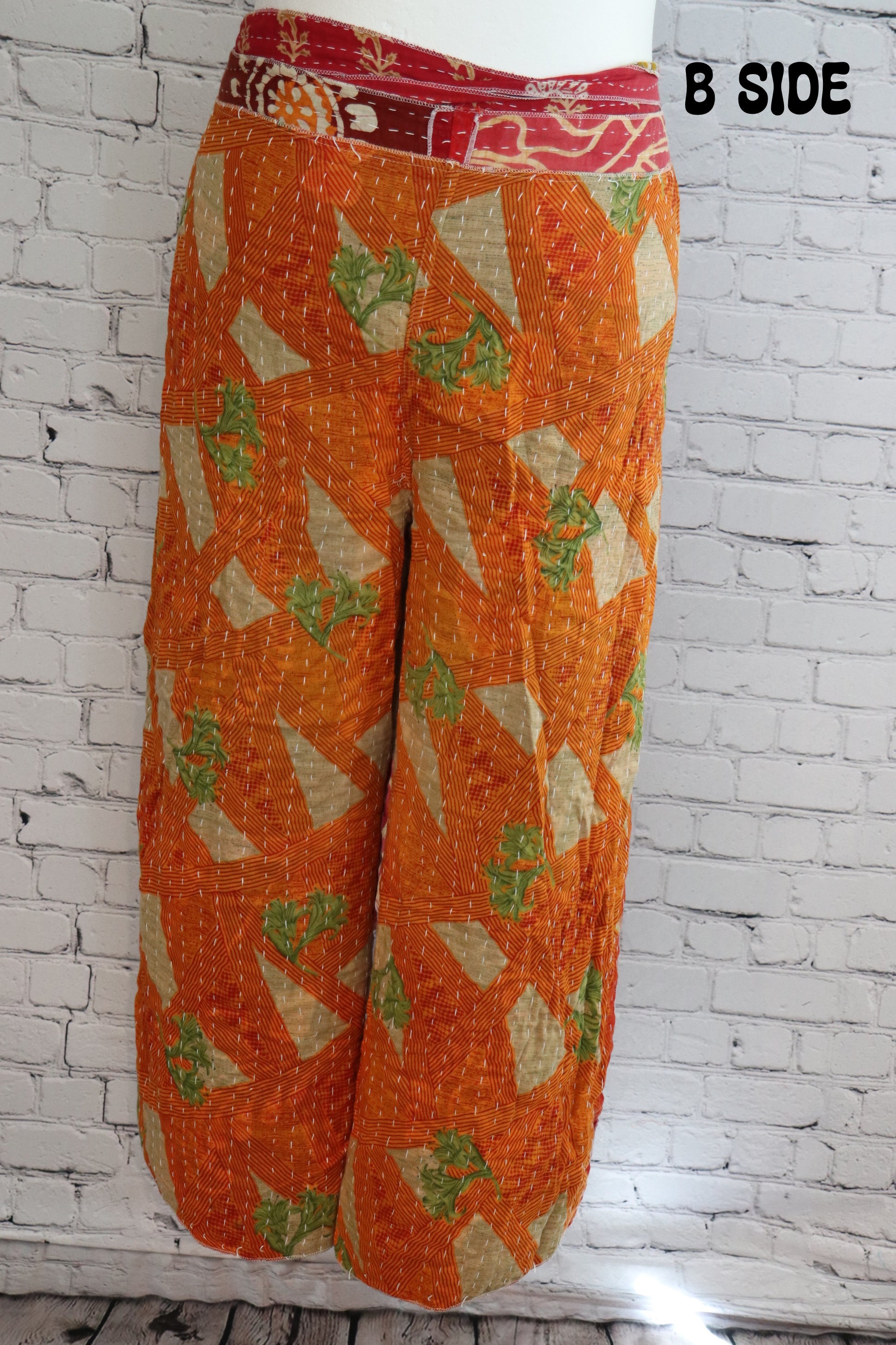 Front view of Ronin Kantha unisex wrap pants, made from recycled sari fabric in boho patchwork design.