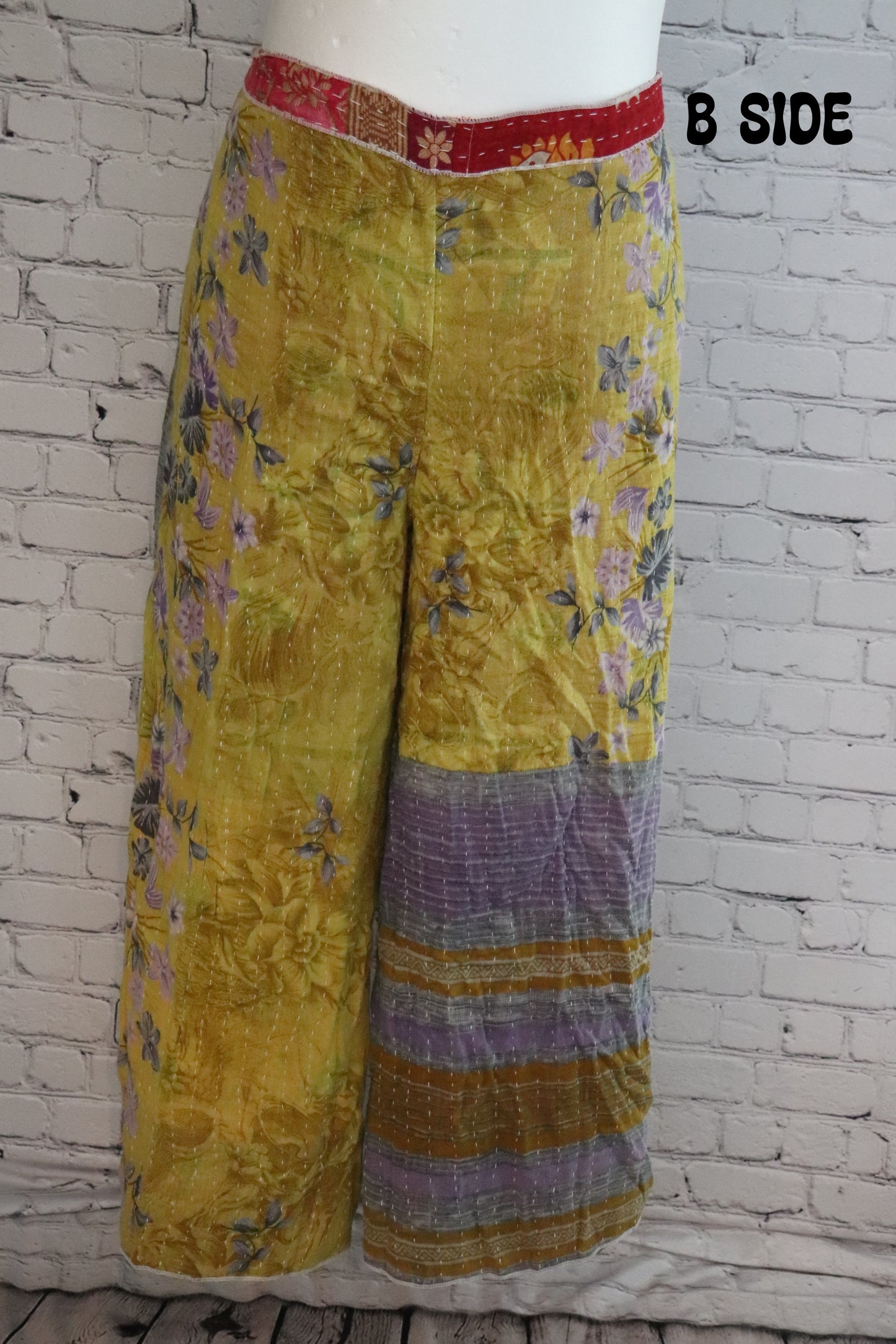 Front view of Ronin Kantha unisex wrap pants, made from recycled sari fabric in boho patchwork design.