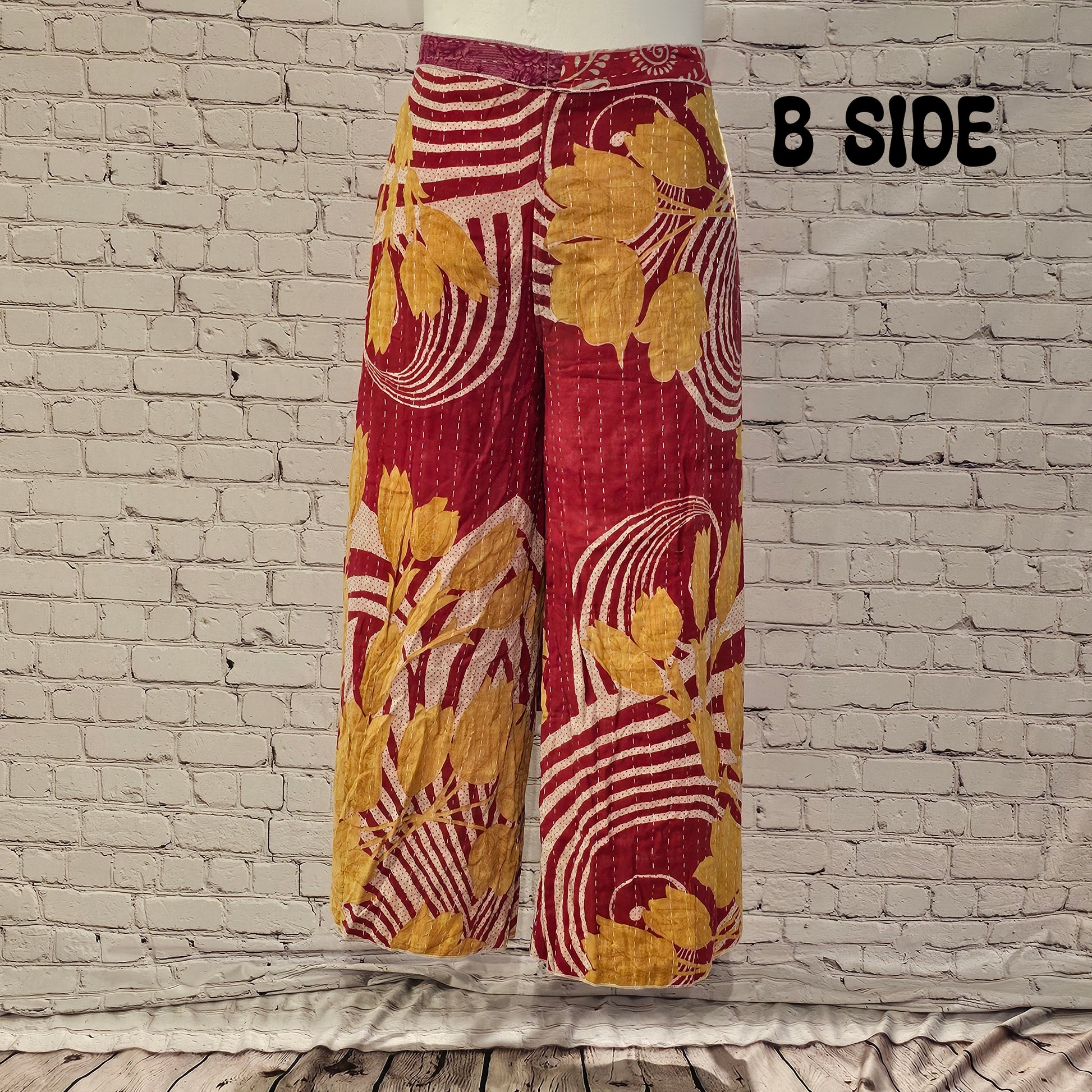 Front view of Ronin Kantha unisex wrap pants, made from recycled sari fabric in boho patchwork design.