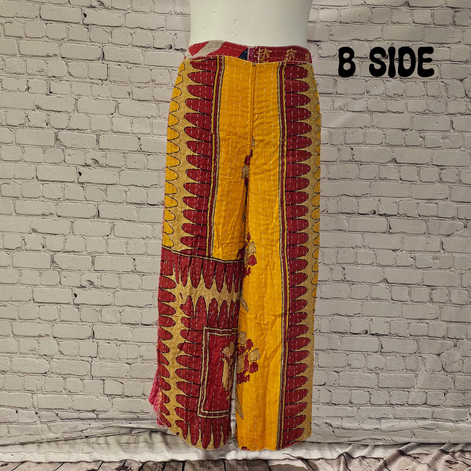 Front view of Ronin Kantha unisex wrap pants, made from recycled sari fabric in boho patchwork design.