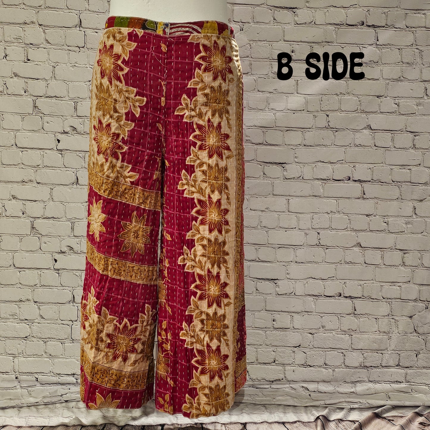 Front view of Ronin Kantha unisex wrap pants, made from recycled sari fabric in boho patchwork design.
