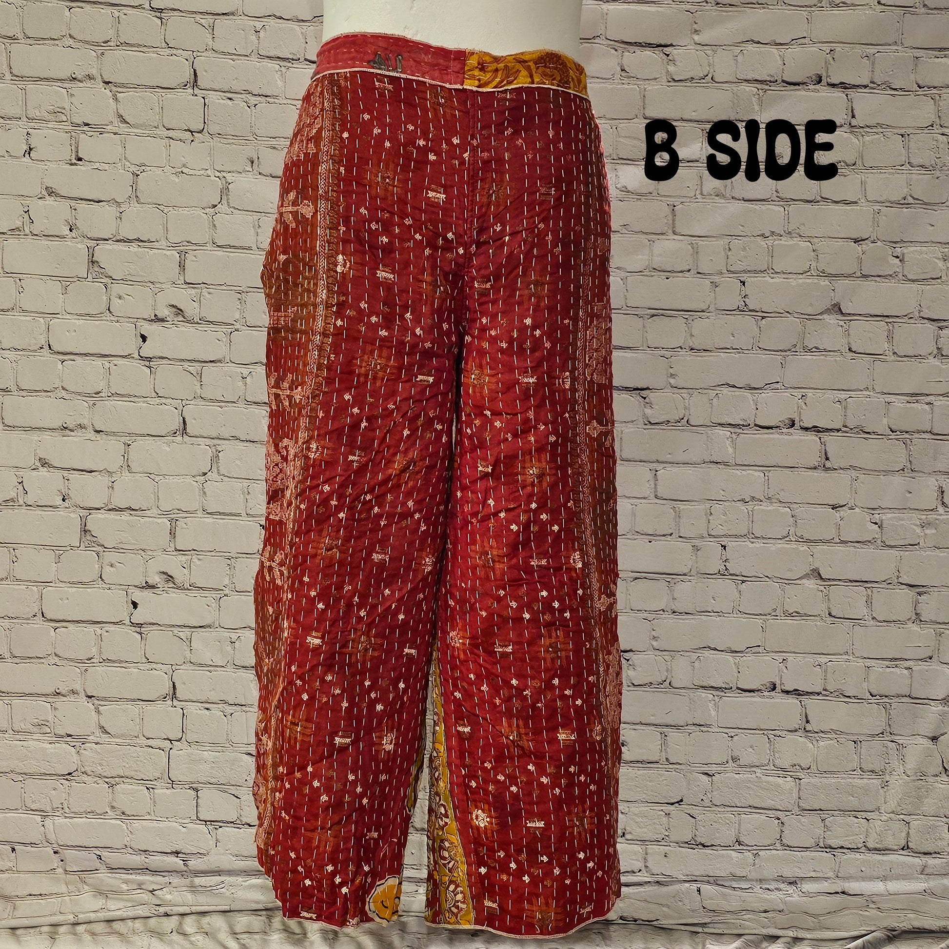 Front view of Ronin Kantha unisex wrap pants, made from recycled sari fabric in boho patchwork design.