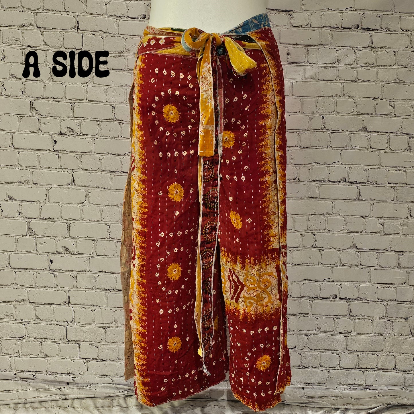 Front view of Ronin Kantha unisex wrap pants, made from recycled sari fabric in boho patchwork design.