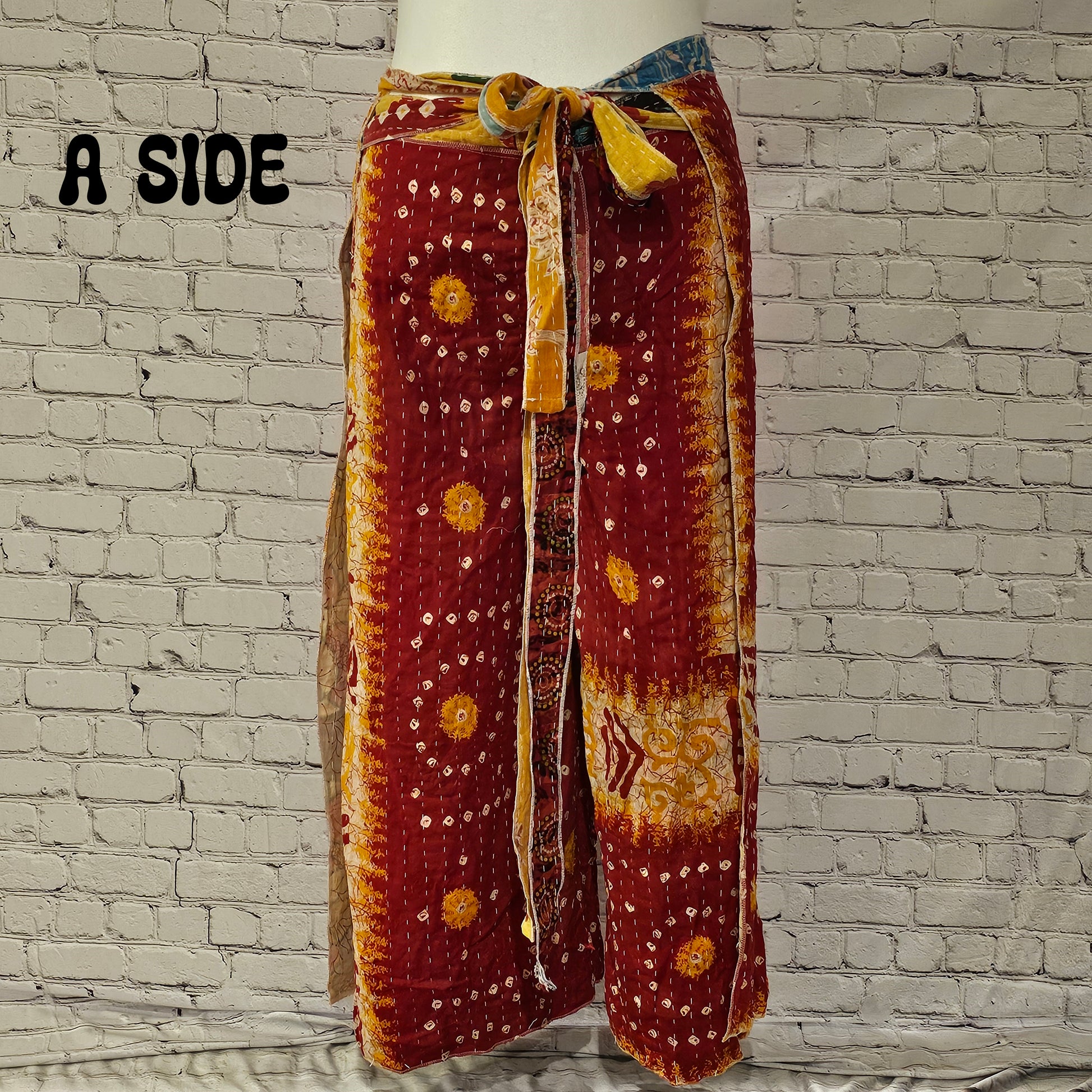 Front view of Ronin Kantha unisex wrap pants, made from recycled sari fabric in boho patchwork design.