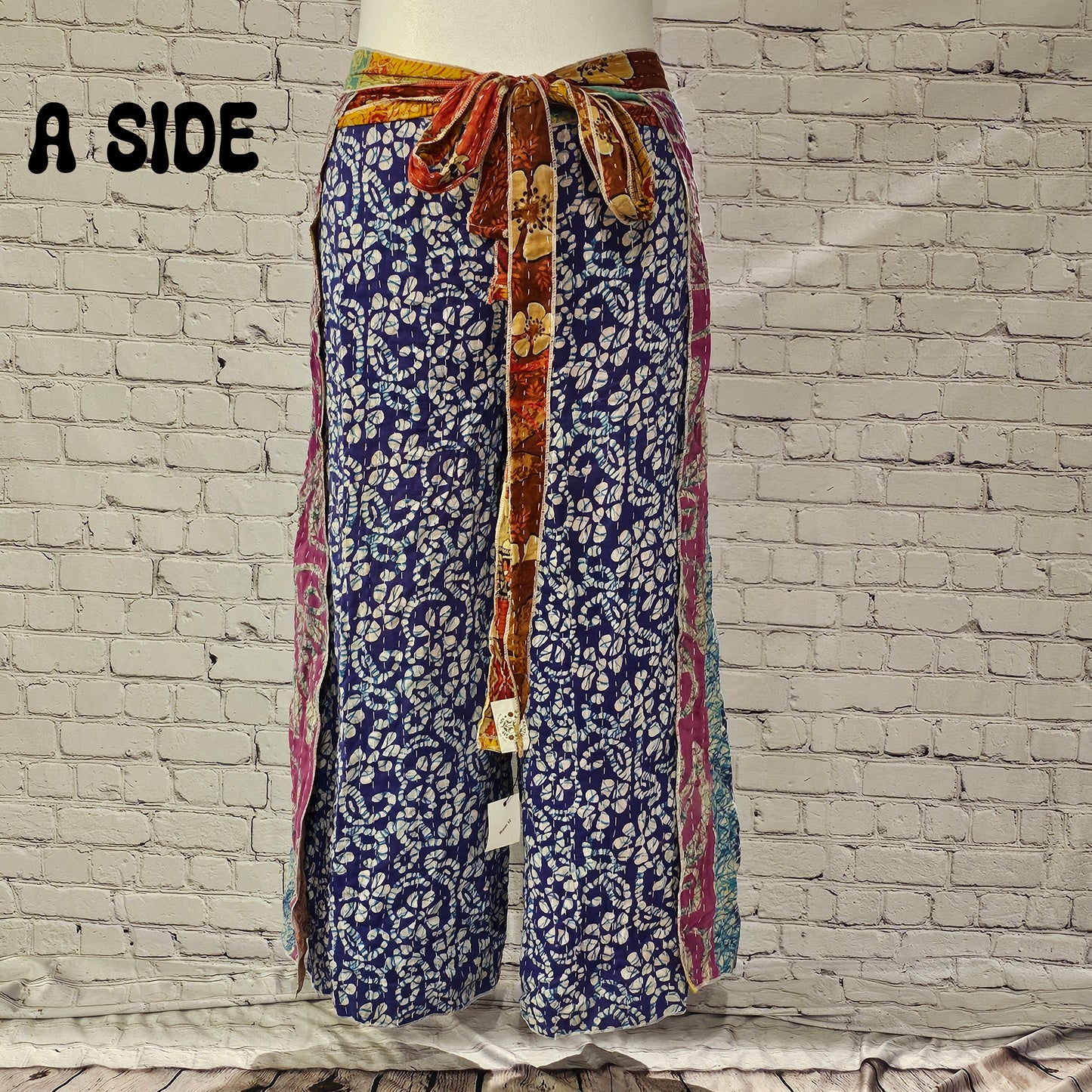Front view of Ronin Kantha unisex wrap pants, made from recycled sari fabric in boho patchwork design.