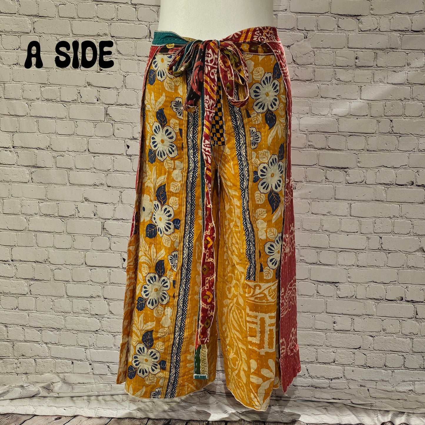 Front view of Ronin Kantha unisex wrap pants, handmade from recycled sari fabric in boho patchwork design.