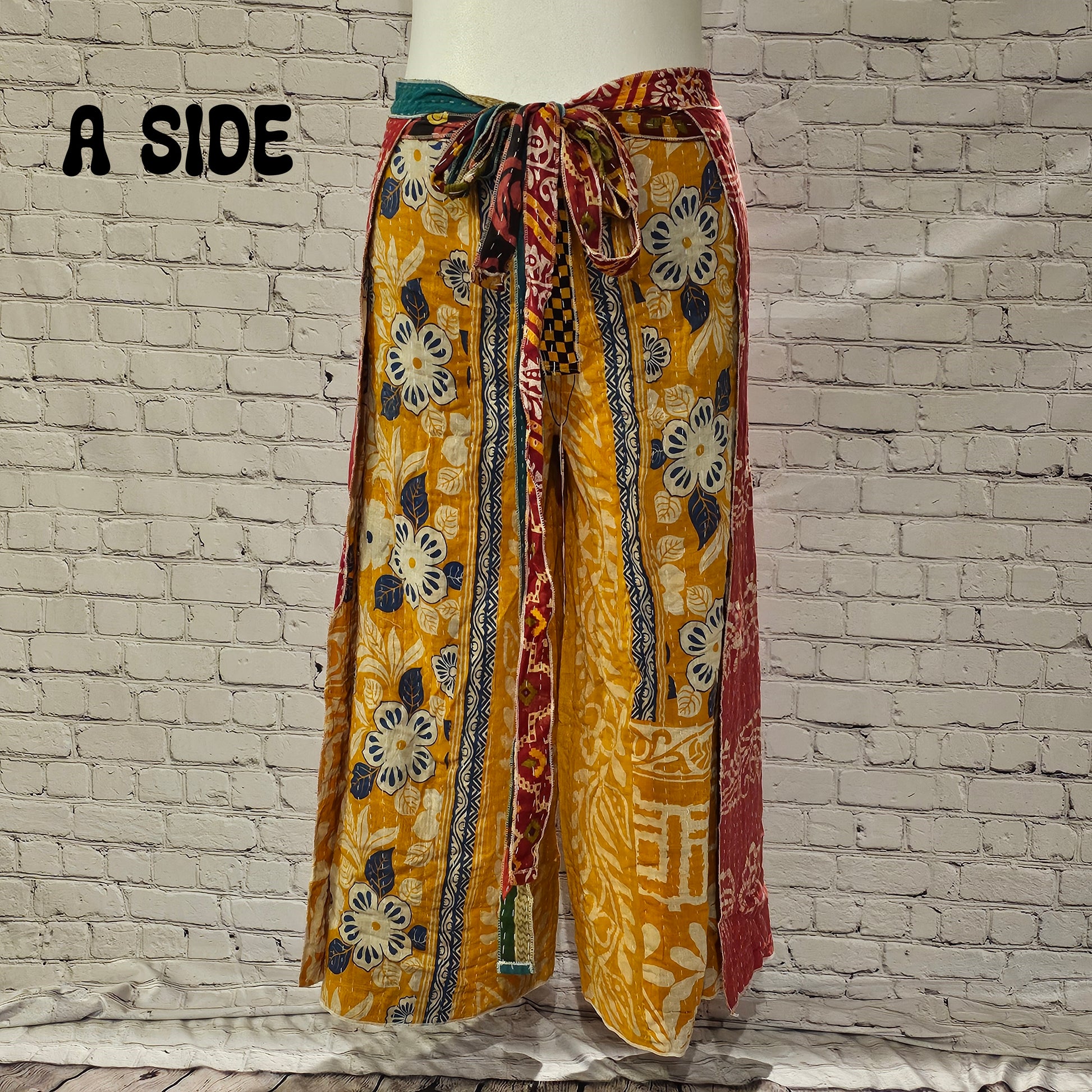 Front view of Ronin Kantha unisex wrap pants, made from recycled sari fabric in boho patchwork design.