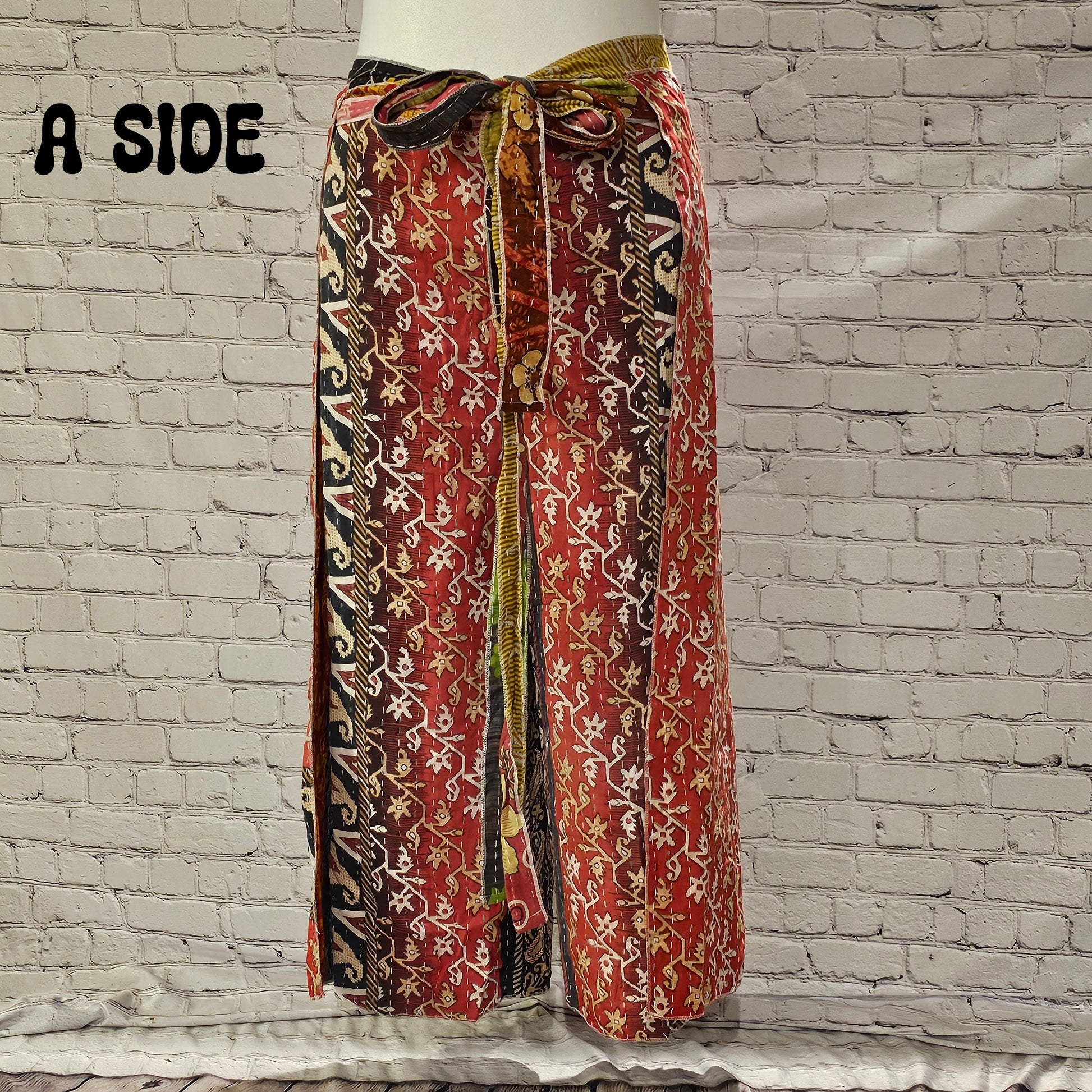 Front view of Ronin Kantha unisex wrap pants, made from recycled sari fabric in boho patchwork design.