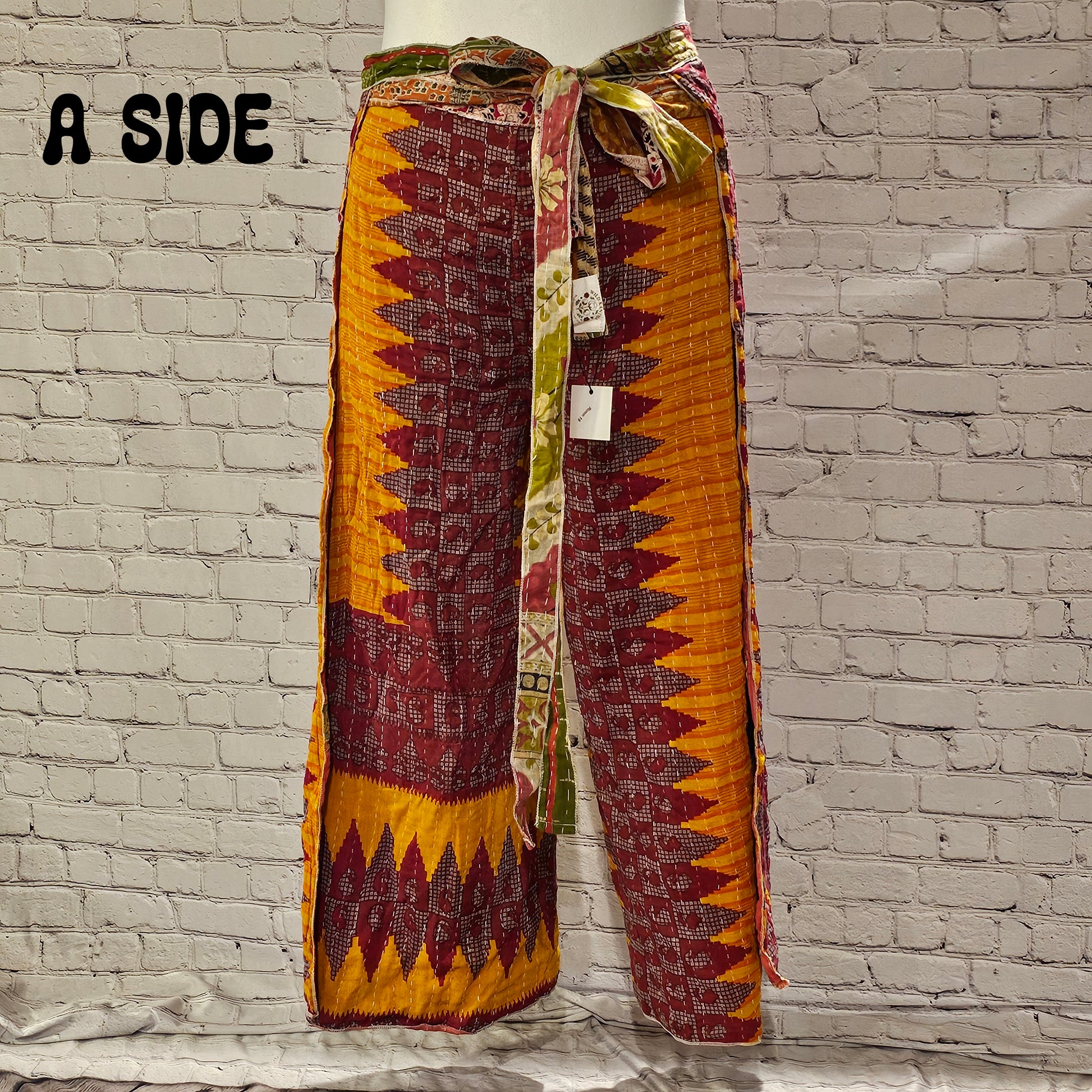 Front view of Ronin Kantha unisex wrap pants, made from recycled sari fabric in boho patchwork design.