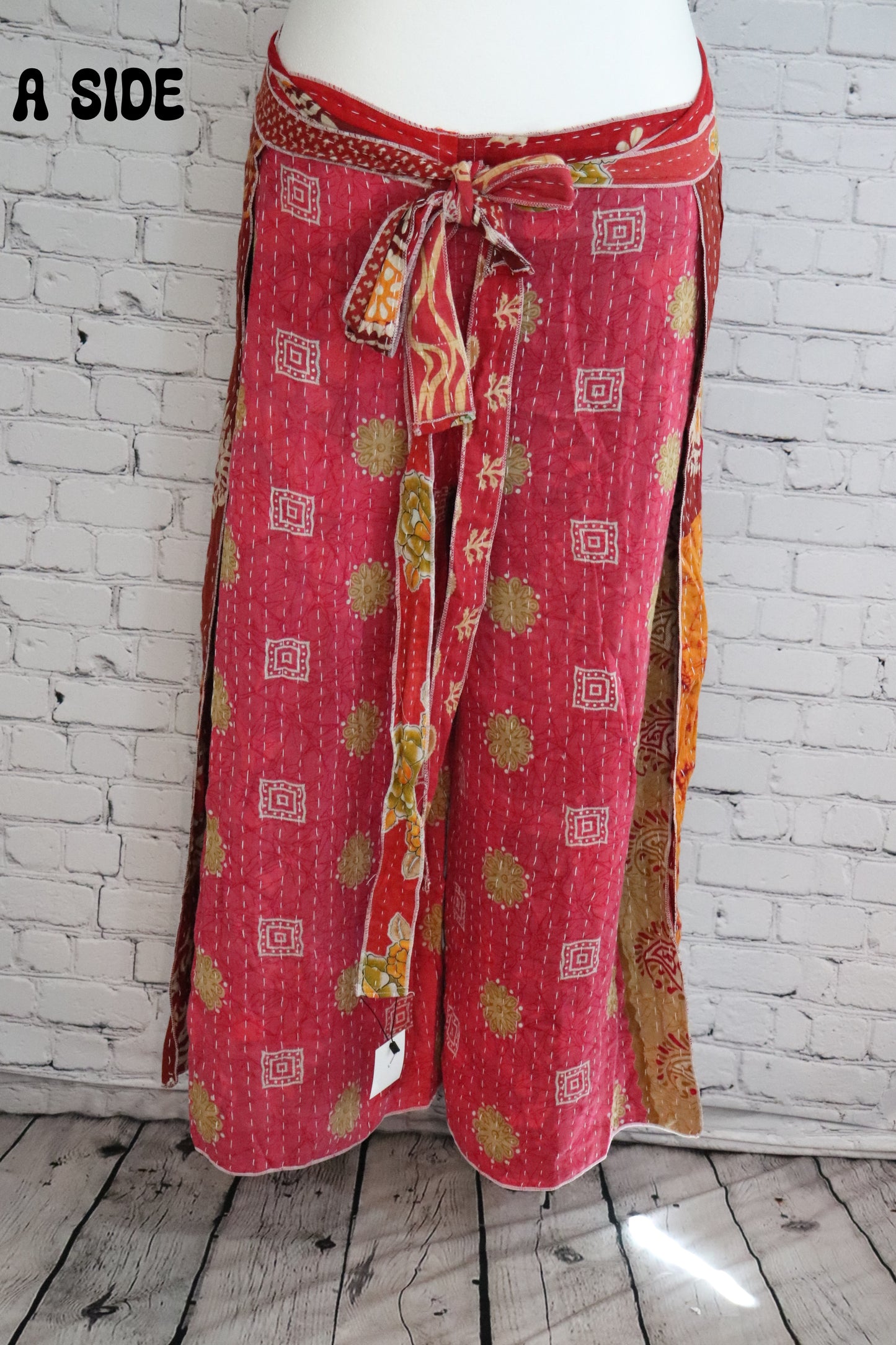 Front view of Ronin Kantha unisex wrap pants, made from recycled sari fabric in boho patchwork design.