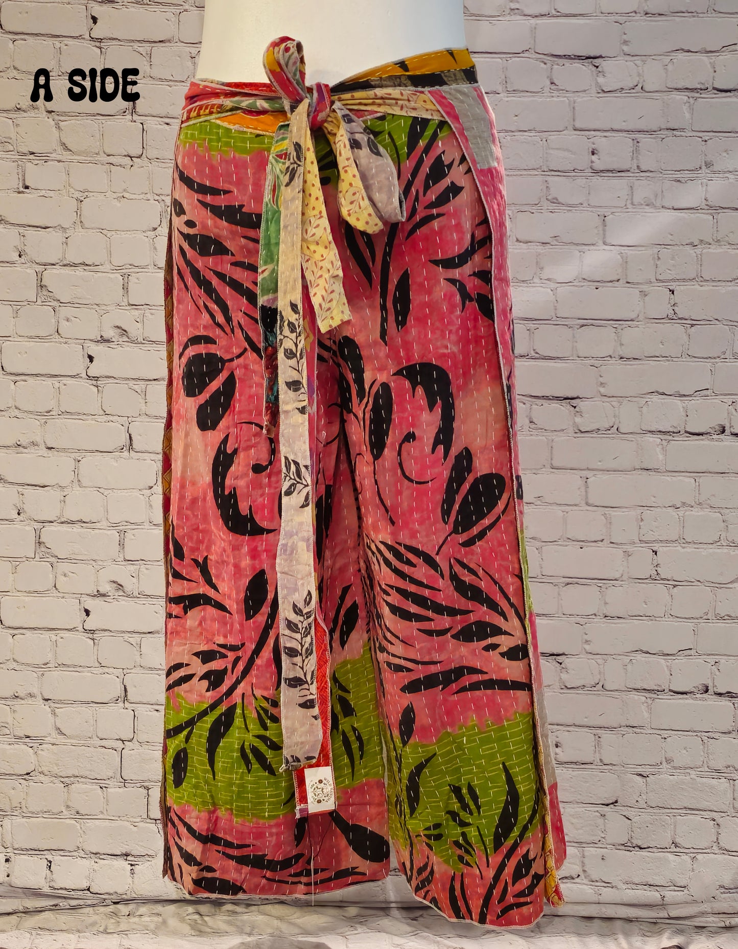 Front view of Ronin Kantha unisex wrap pants, made from recycled sari fabric in boho patchwork design.