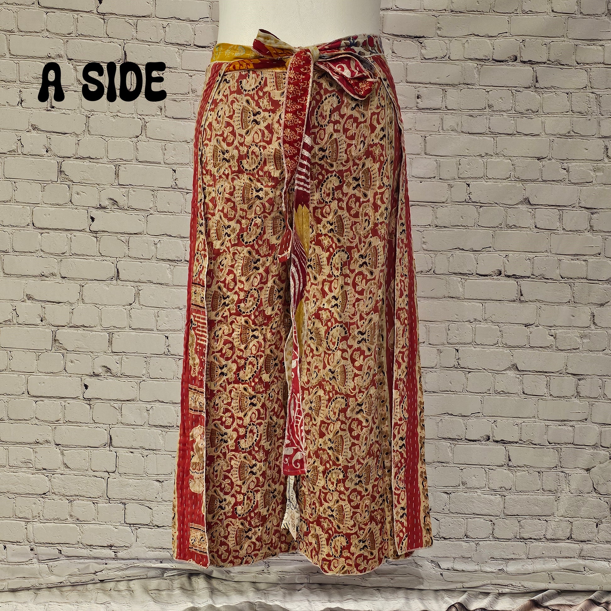Front view of Ronin Kantha unisex wrap pants, made from recycled sari fabric in boho patchwork design.