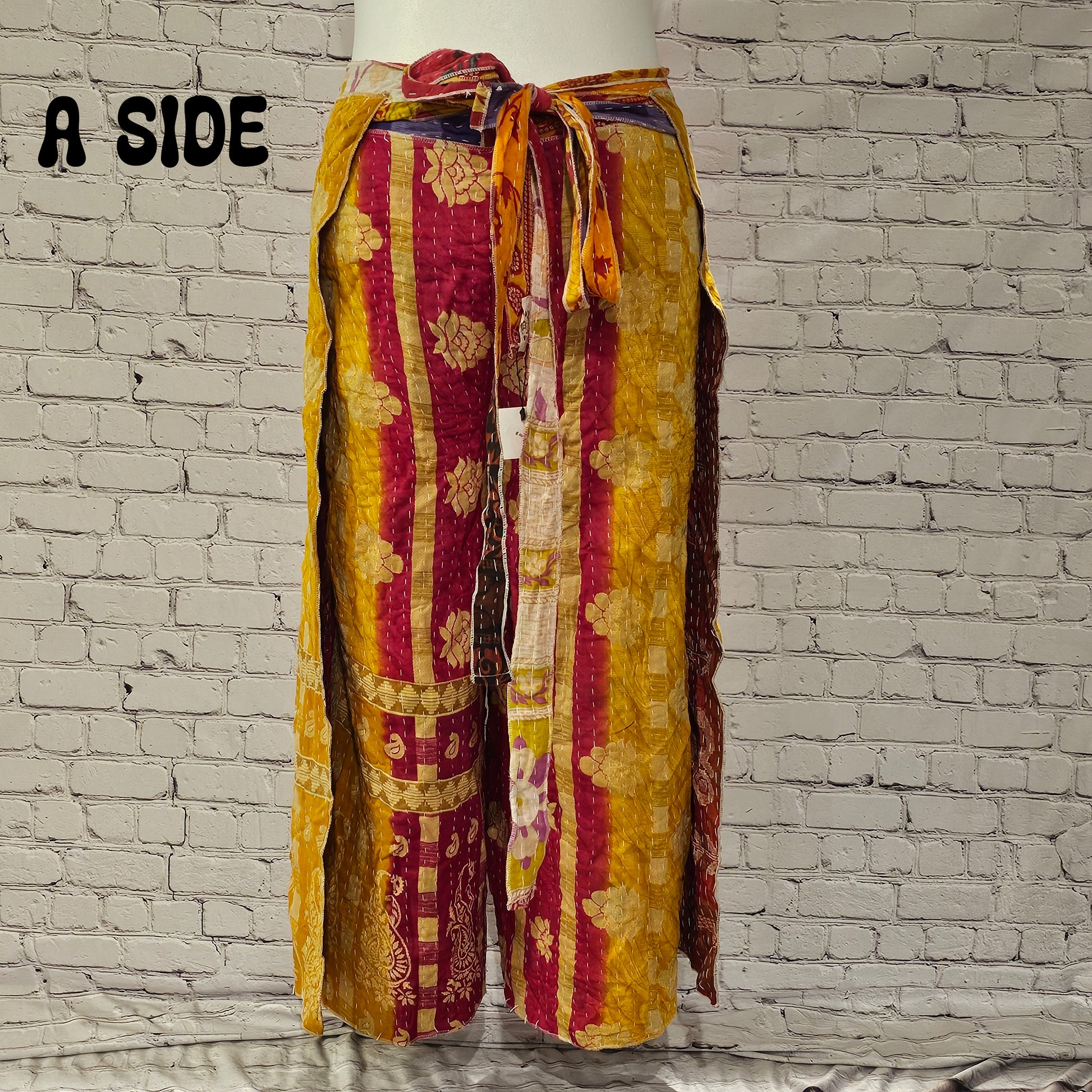 Front view of Ronin Kantha unisex wrap pants, made from recycled sari fabric in boho patchwork design.