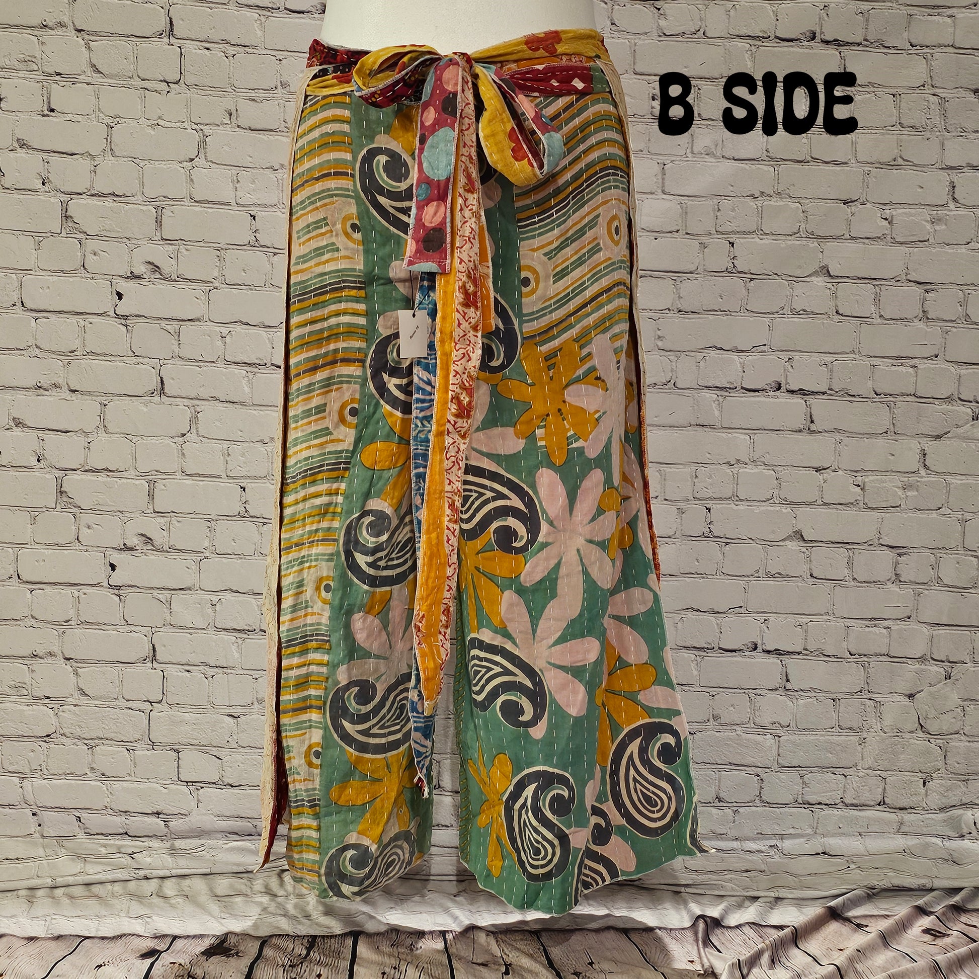 Front view of Ronin Kantha unisex wrap pants, made from recycled sari fabric in boho patchwork design.