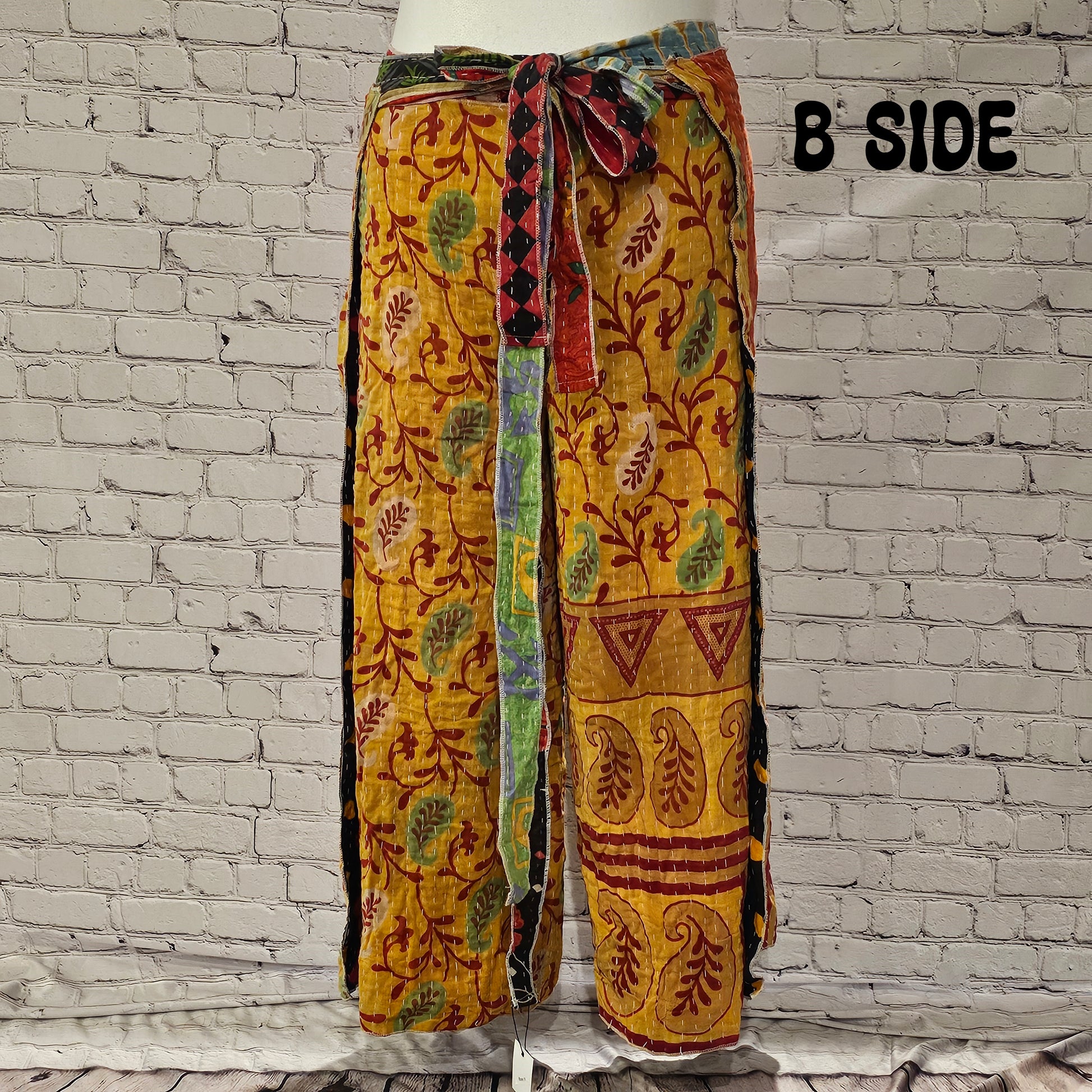 Front view of Ronin Kantha unisex wrap pants, made from recycled sari fabric in boho patchwork design.
