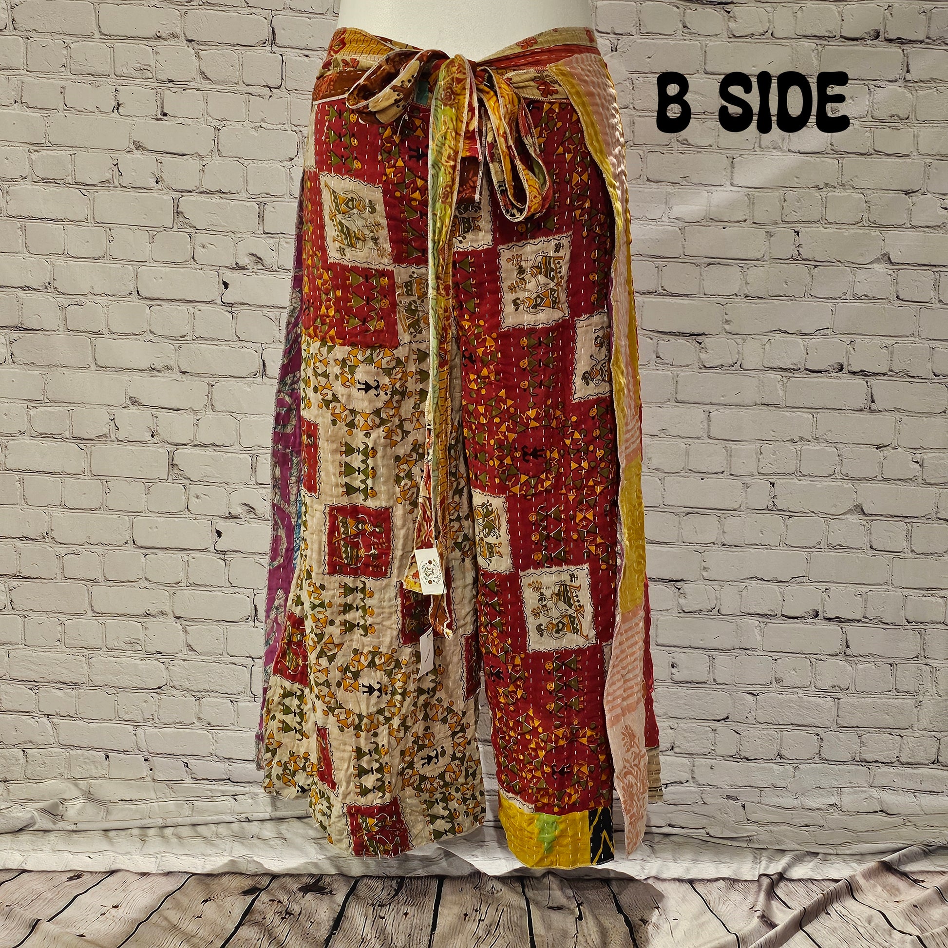 Front view of Ronin Kantha unisex wrap pants, made from recycled sari fabric in boho patchwork design.